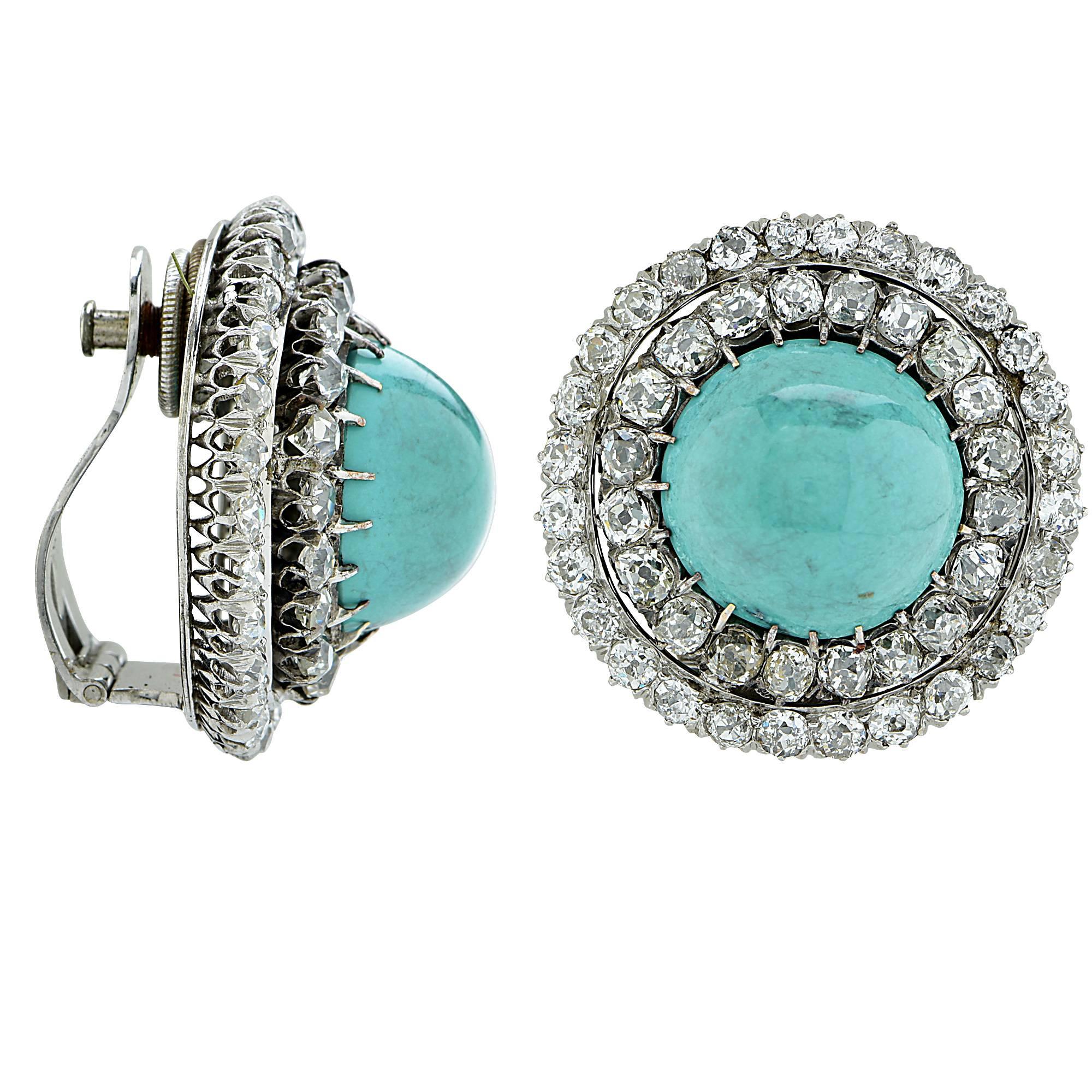 9k white gold earrings containing 2 high dome turquoise cabochons surround by 110 old European and mine cut diamonds weighing approximately 8cts. 

Metal weight: 23.94 grams

These diamond and turquoise earrings are accompanied by a retail appraisal