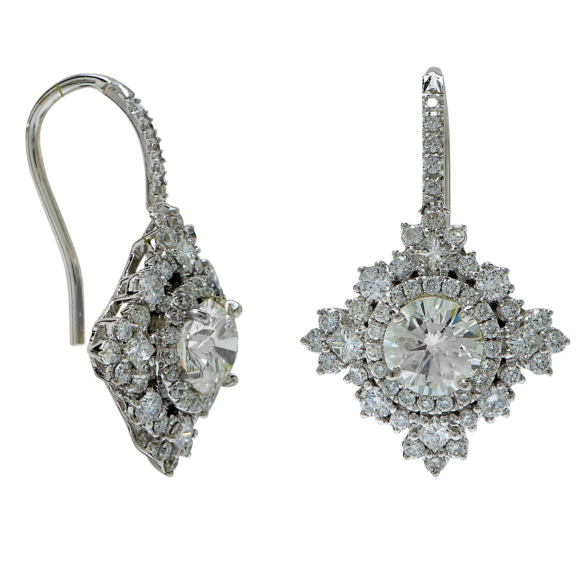 18k white gold earrings featuring 2 round brilliant cut diamonds weighing 1.50cts total, G color, SI3 clarity, accented by 114 round brilliant cut diamonds weighing 1.24cts total, G color VS clarity.

These diamond earrings are accompanied by a