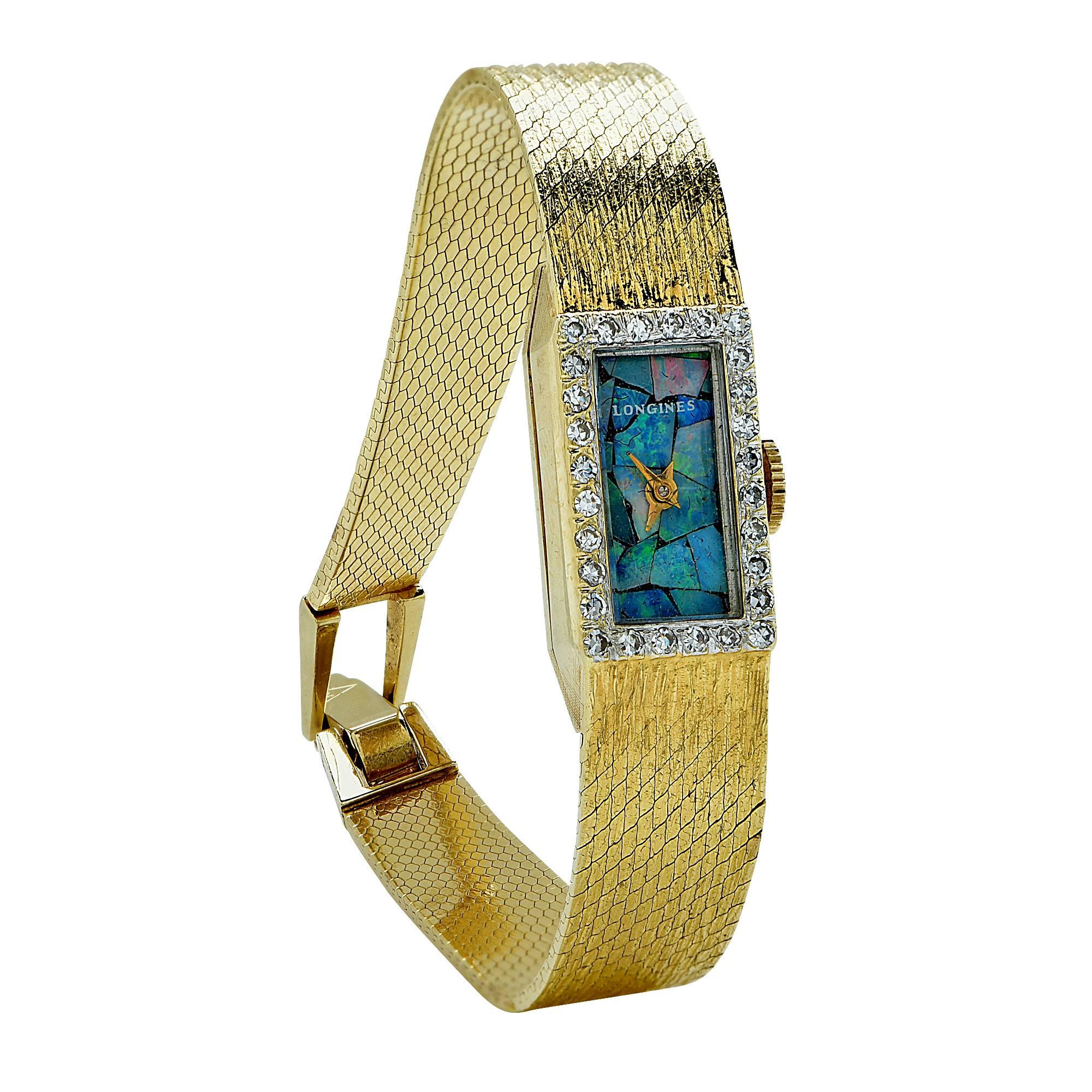 14k yellow gold Longines watch featuring an opal face and a diamond bezel.

Metal weight: 23.79 grams

This diamond and opal watch is accompanied by a retail appraisal performed by a Graduate Gemologist.