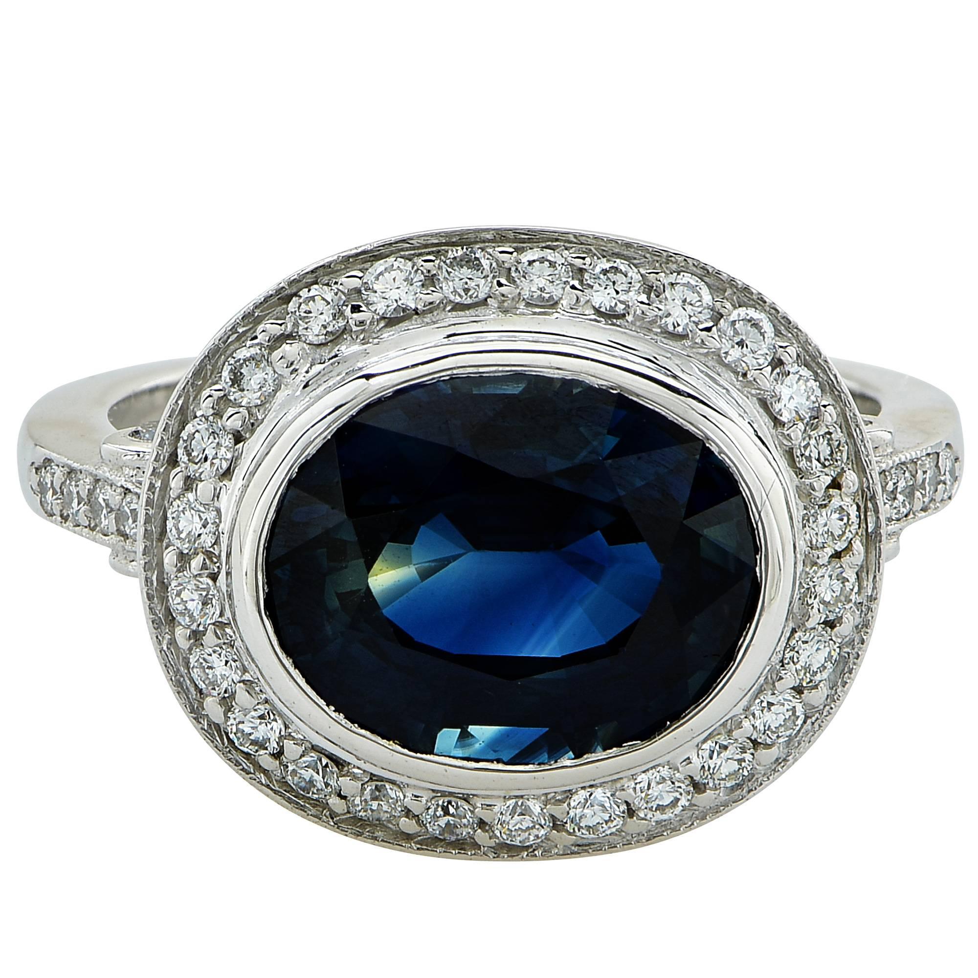 Platinum custom-made ring featuring a 4.31ct oval cut blue sapphire accented by approximately .50cts of round brilliant cut diamonds, G color, VS clarity.

Ring size: 6 (can be sized up or down free of charge)
Metal weight: 7.79 grams

This