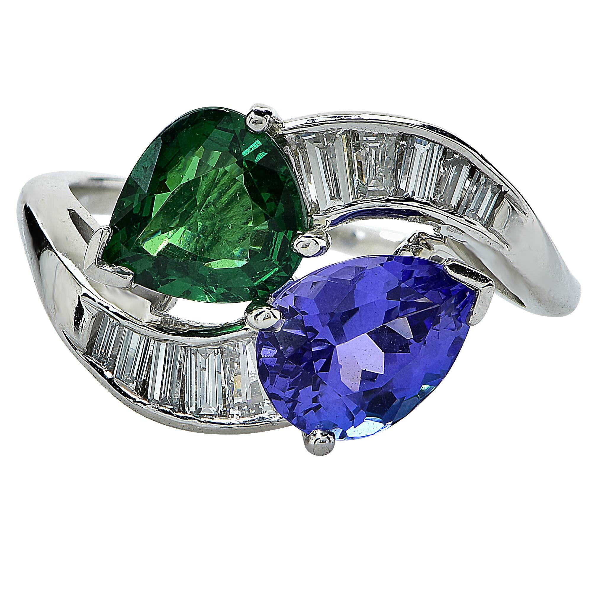 Platinum ring featuring a pear shape Tanzanite weighing 1.93cts , flanked by a pear shape Tsavorite garnet weighing 1.70cts total, accented by approximately .60cts total of baguette cut diamonds, G color, VS clarity.

Ring size: 6 (can be sized up