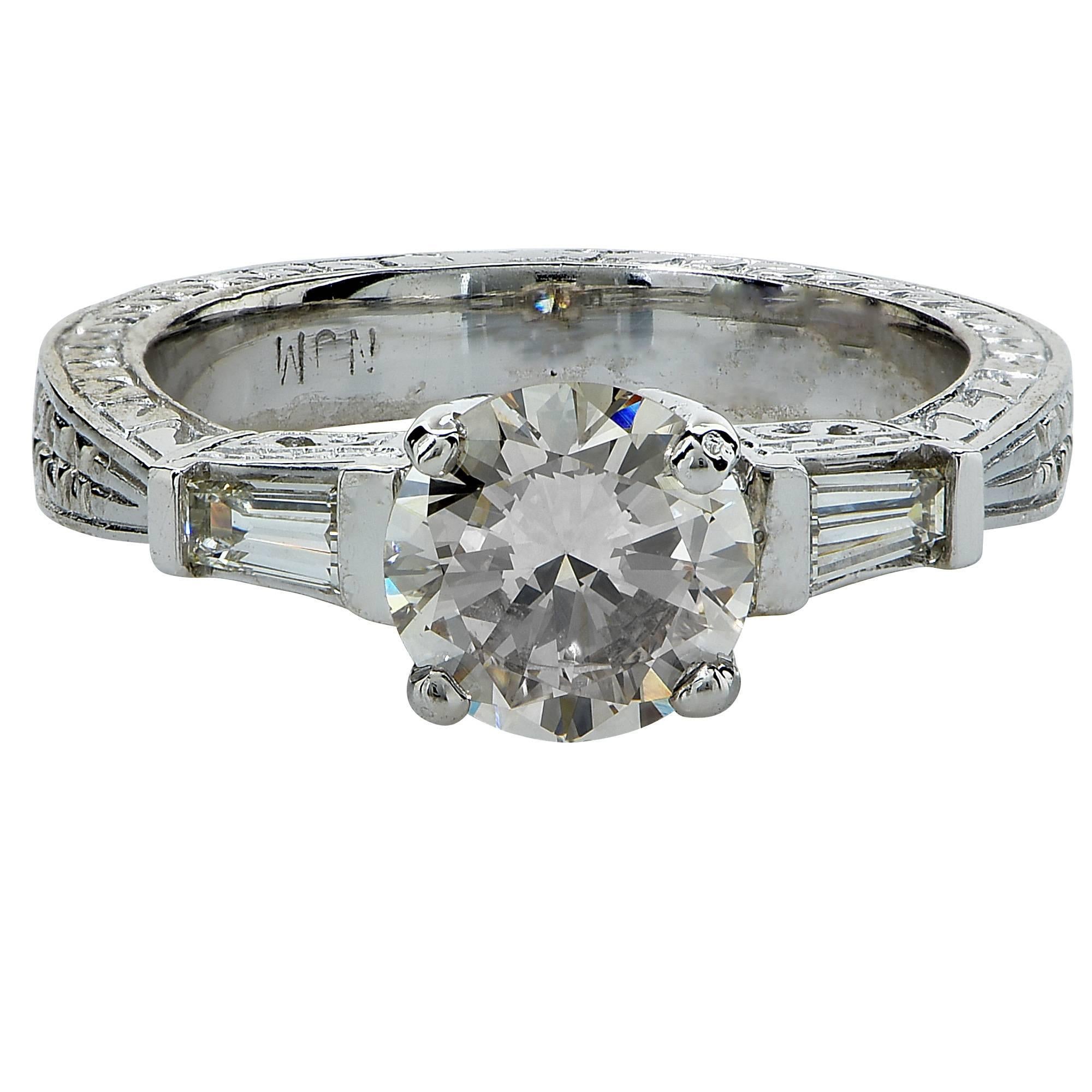 Platinum ring featuring a 1.09ct round brilliant cut diamond, I color, VS clarity, accented by .40cts of baguette cut diamonds G color, VS clarity.

Ring size: 6 (can be sized up or down free of charge)
Metal weight: 7.94 grams

This diamond