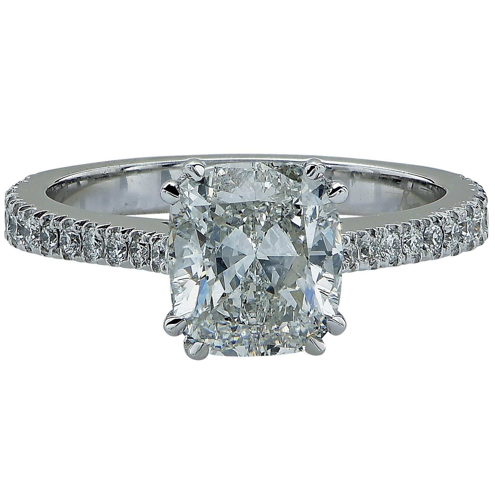 This delightful ring features a 2.03 carat cushion cut diamond GIA graded, G color, SI1 clarity set in 18k white gold and flanked by 24 round brilliant cut diamonds with a total weight of .30cts, G color, VS clarity.

Ring size: 6 (can be sized up