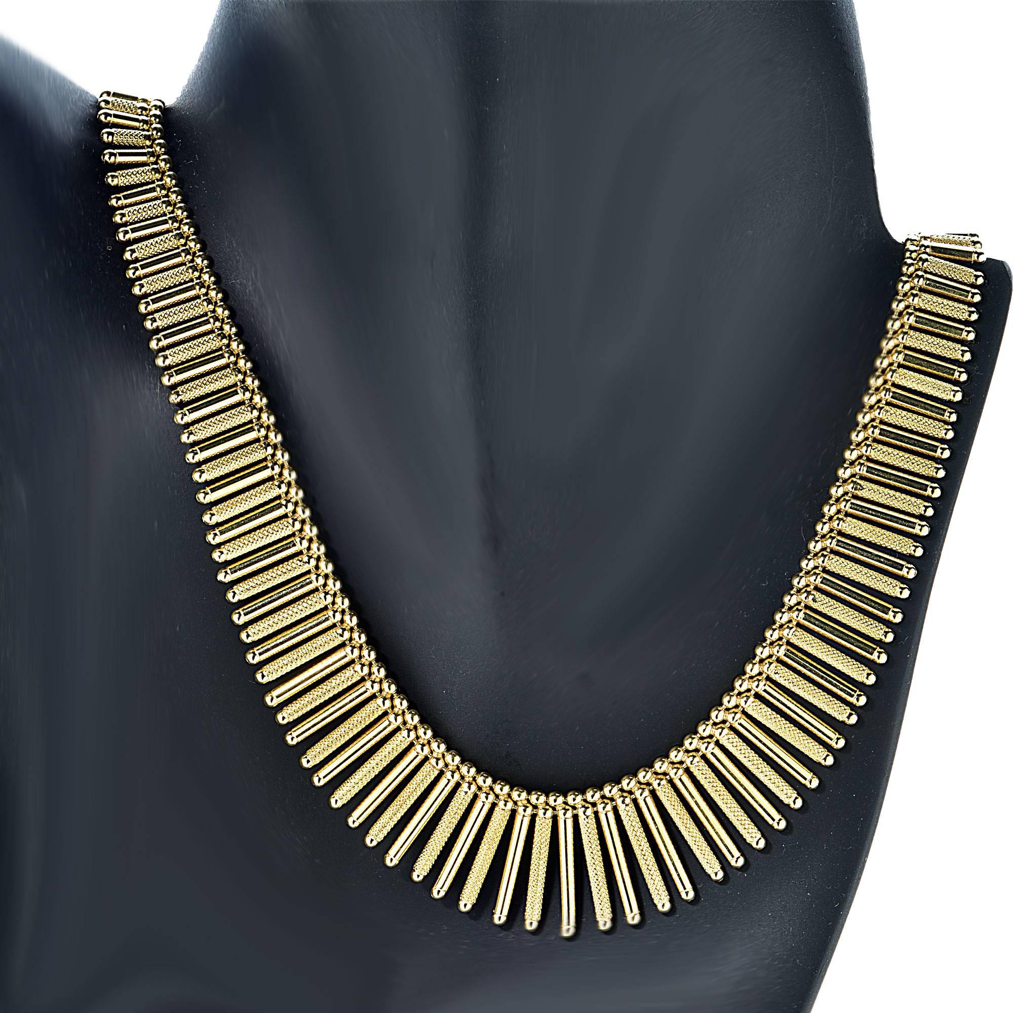 This stunning Italian 18k yellow gold bib necklace features textured and smooth gold bars intermittently arranged accented by gold spheres.

Measurements available upon request.
It is stamped and/or tested as 18k gold.
The metal weight is 52.50