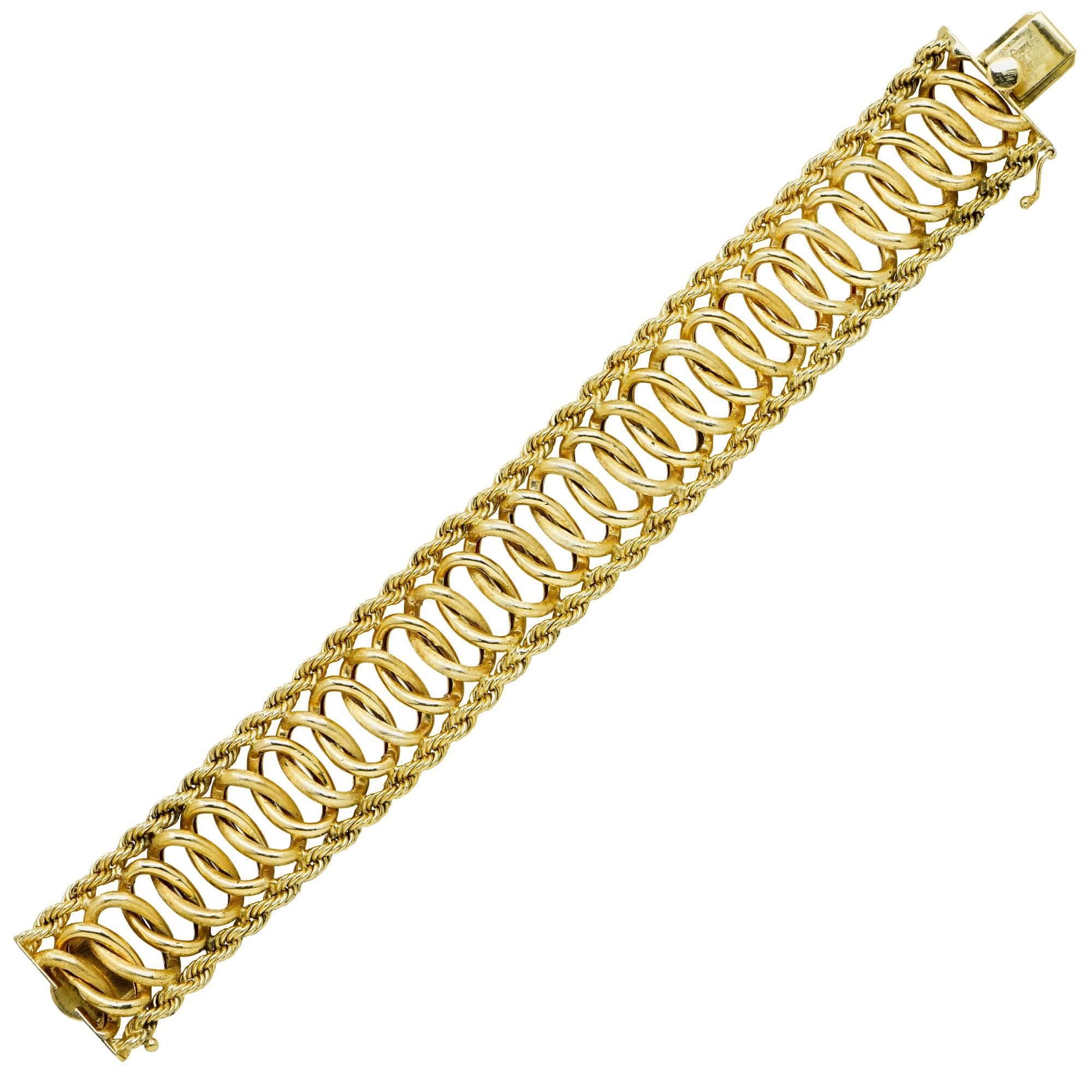 Modern weave and rope bracelet featuring repeating interwoven circles flanked by rope chain in 14Kt yellow gold.

Metal weight: 48.74 grams

This yellow gold bracelet is accompanied by a retail appraisal performed by a GIA Graduate Gemologist.