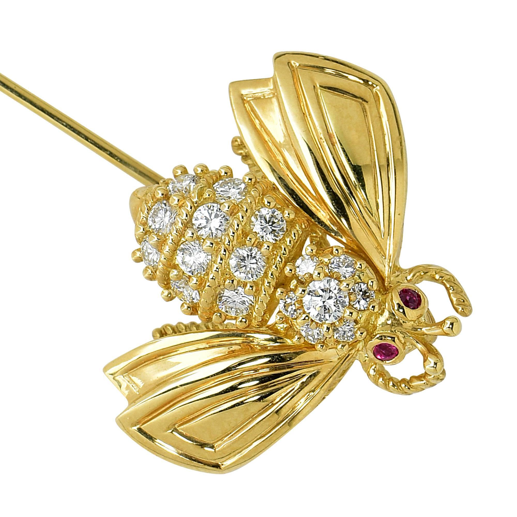 18k yellow gold Tiffany & Co. stick pin featuring 14 round brilliant cut diamond weighing approximately .65cts total, G color VS clarity, accented by 2 rubies weighing .02cts total. 