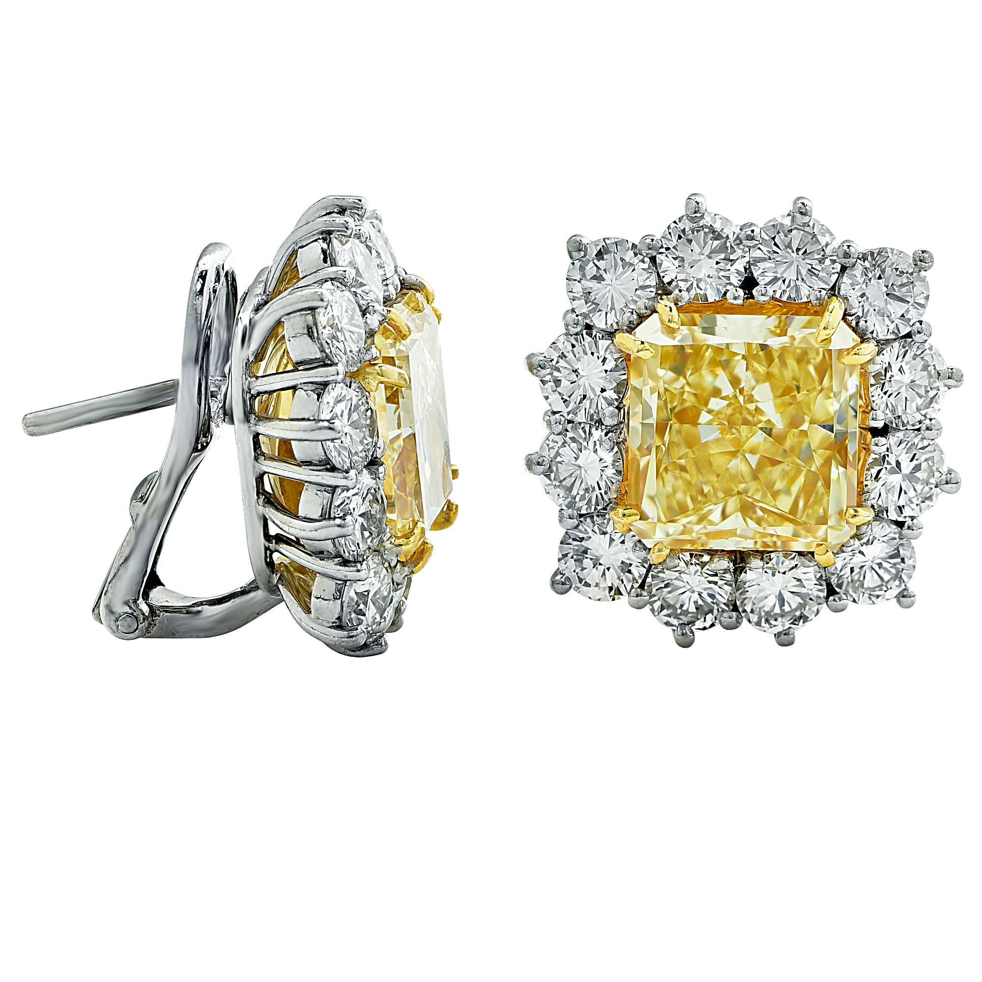 Magnificent pair of GIA graded 5.36ct and 5.01ct fancy light yellow radiant cut diamonds VS1 clarity set in to custom made platinum and 18k yellow gold earrings. These dazzling yellow diamonds are surrounded by 24 round brilliant cut diamonds
