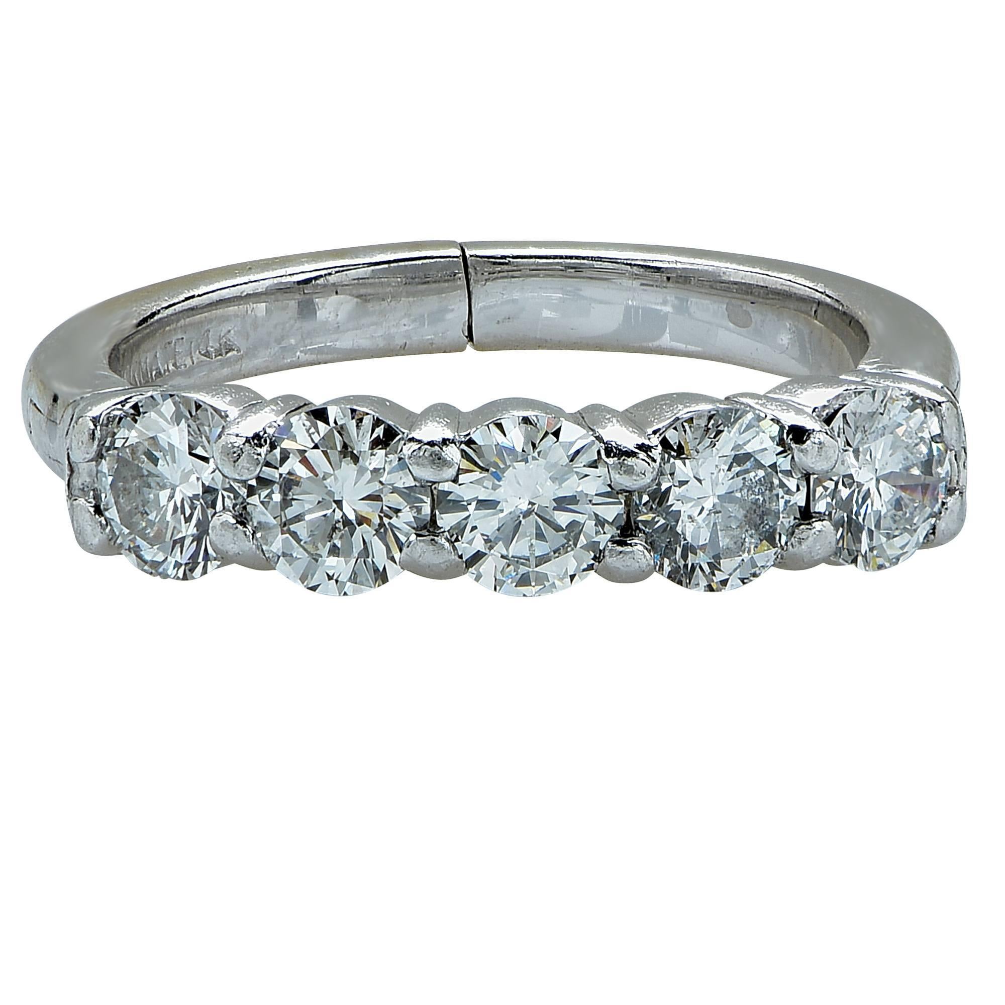 Platinum band featuring 5 round brilliant cut diamonds weighing approximately 1.25cts total, G color, SI clarity.

The ring is a size 5.25 and can be sized up or down.
Measurements are available upon request.
It is stamped and/or tested as