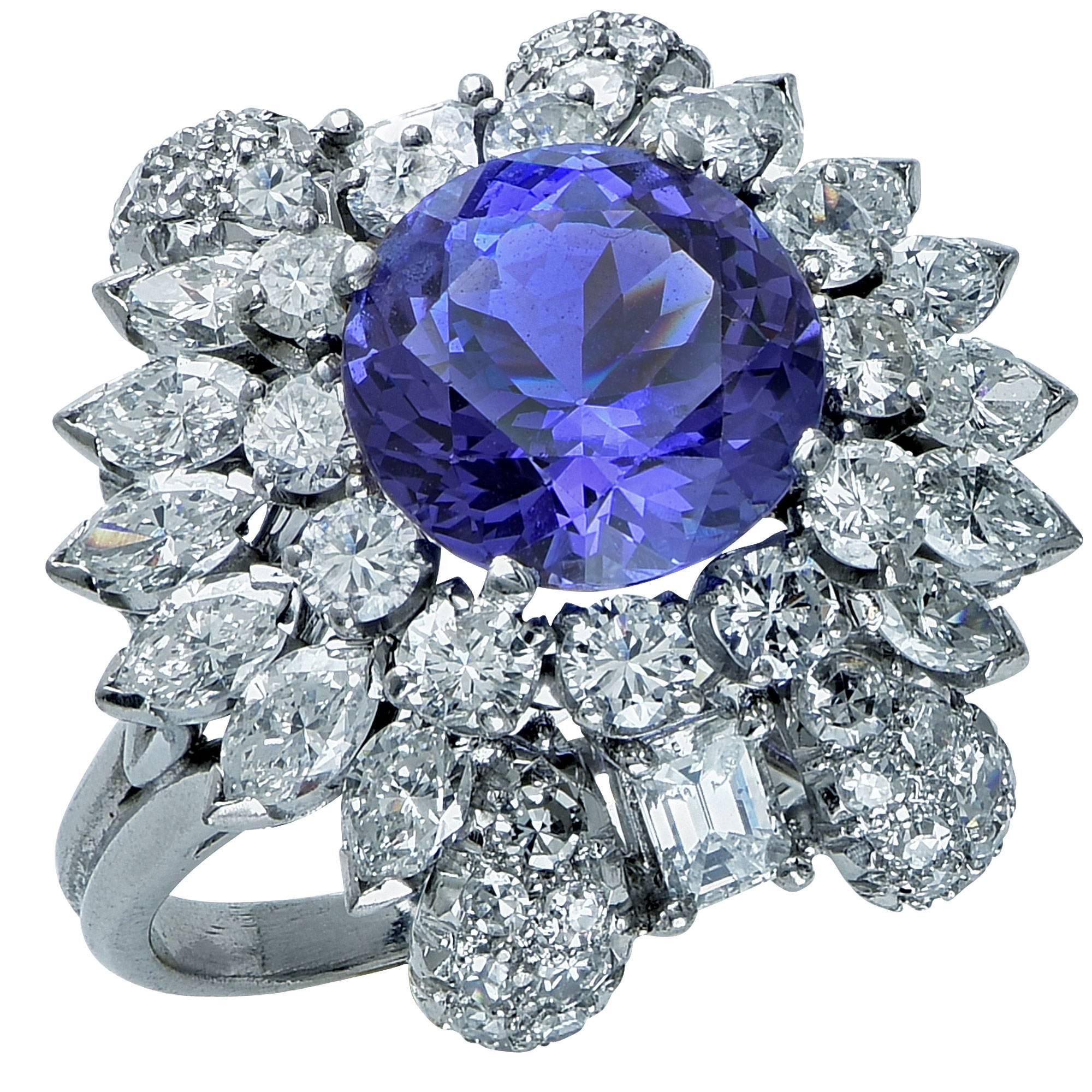 Platinum ring featuring a round cut tanzanite weighing approximately 4.90cts accented by 58 round, marquise and emerald cut diamonds weighing approximately 3.60cts total, G color, VS-SI clarity.

Ring size: 6 (can be sized up or down)
Metal