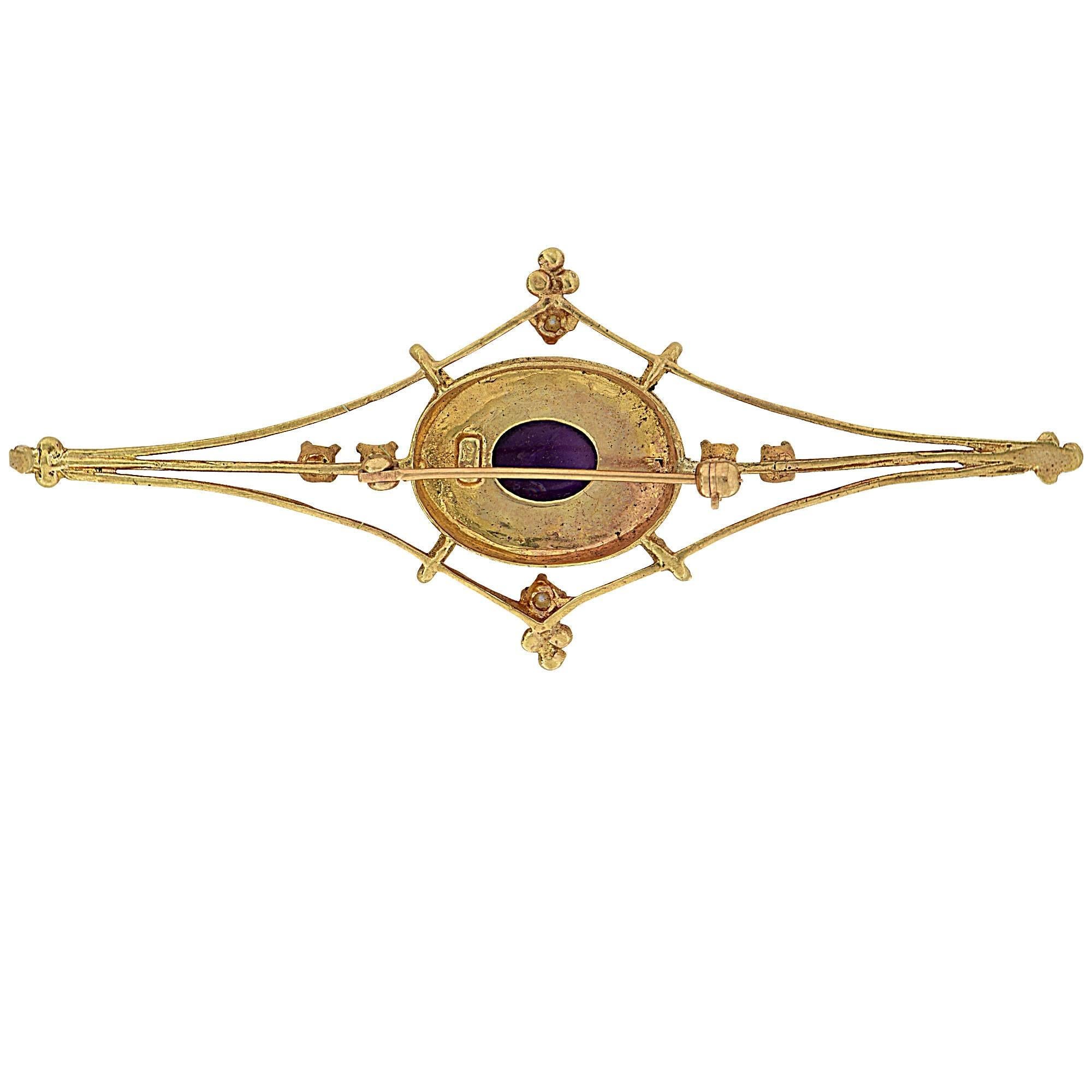 14k yellow gold brooch featuring an Amethyst cabochon accented by seed pearls.

Metal weight:  grams

This brooch is accompanied by a retail appraisal performed by a GIA Graduate Gemologist.