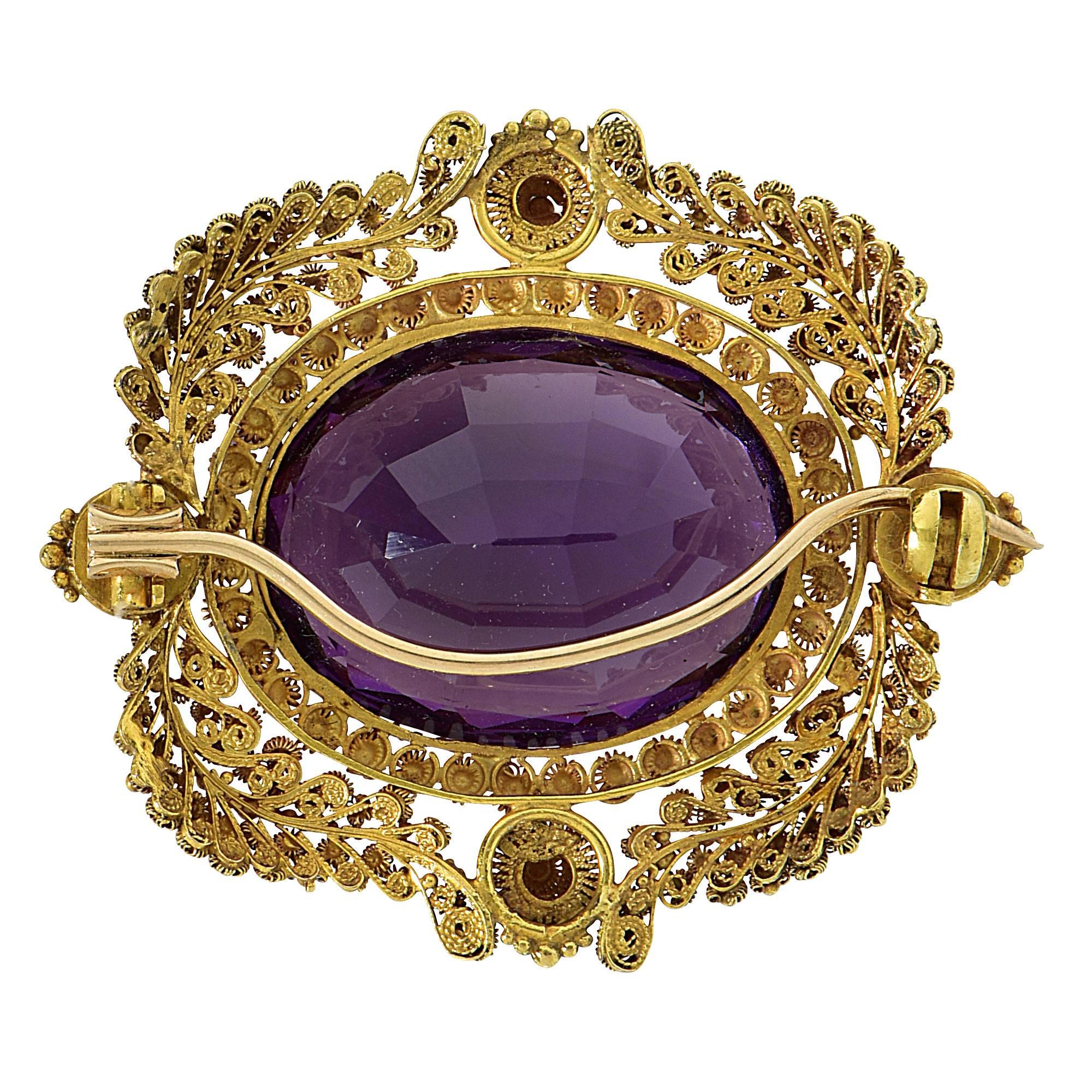20k yellow gold brooch featuring a oval cut amethyst weighing approximately 24cts.

Metal weight: 12.44 grams

This amethyst brooch is accompanied by a retail appraisal performed by a GIA Graduate Gemologist.