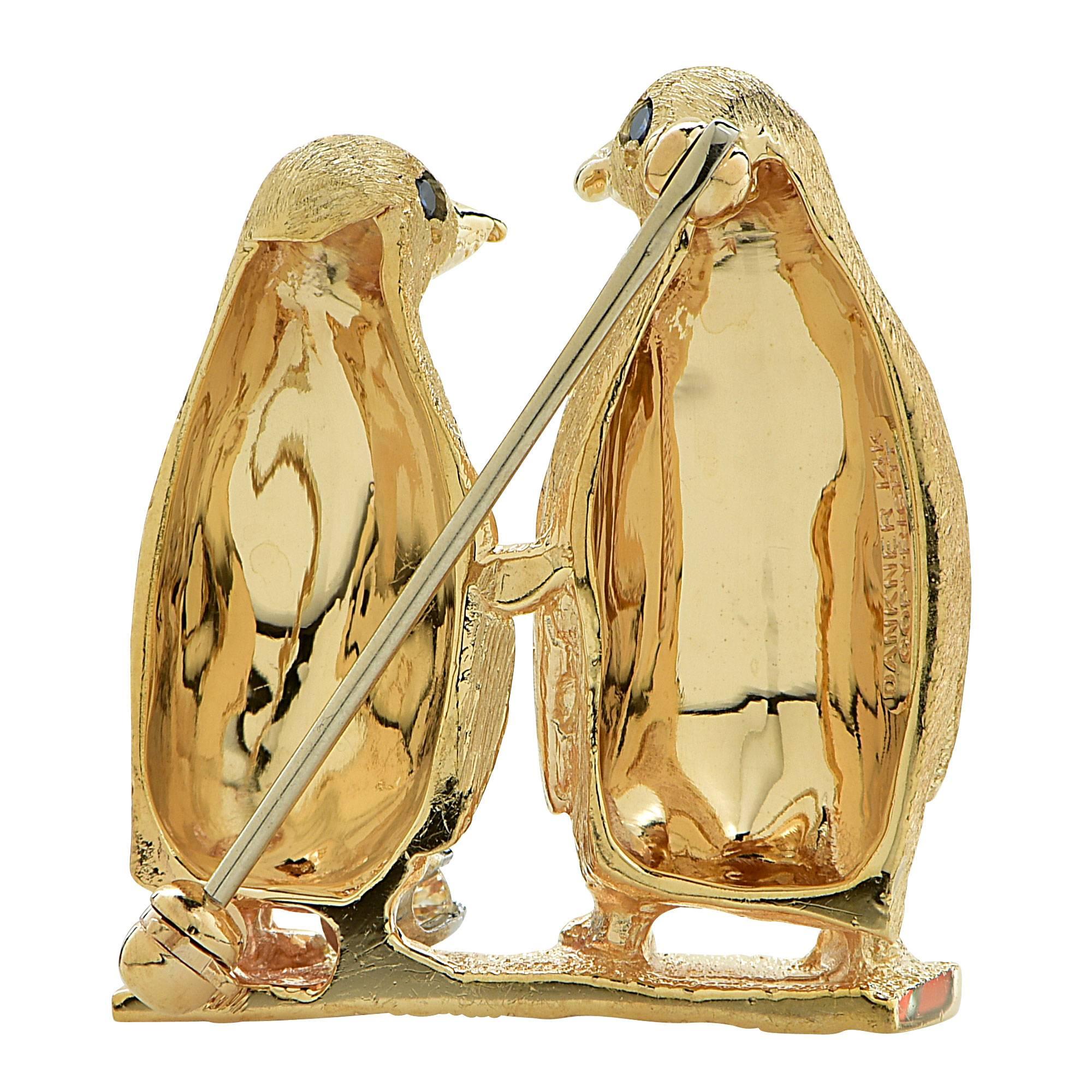 14k yellow gold Penguin brooch featuring 2 round cut sapphires for eyes.

Metal weight: 10.88 grams

This sapphire penguin brooch is accompanied by a retail appraisal performed by a GIA Graduate Gemologist.
