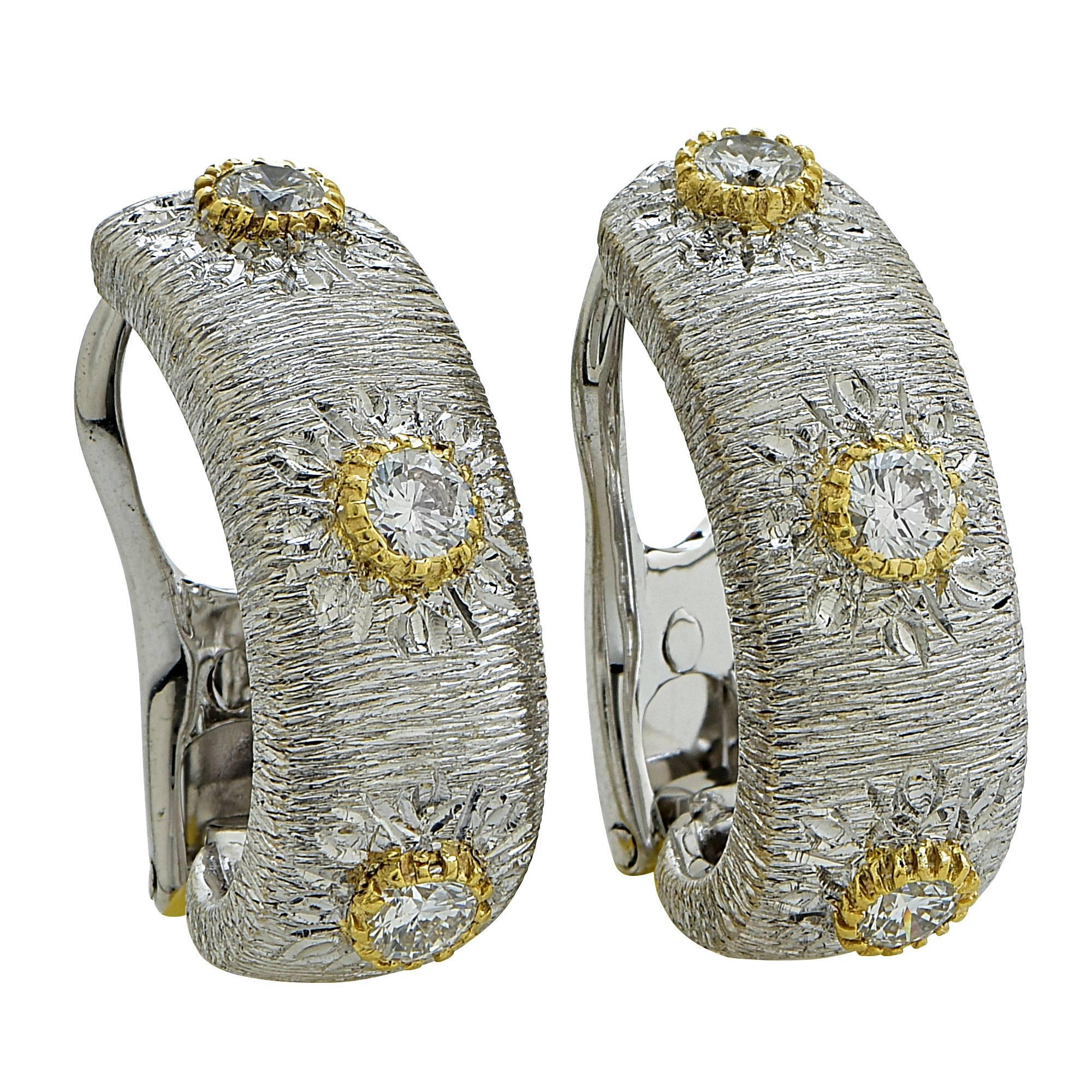 18k white and yellow gold hoop earrings featuring 6 round brilliant cut diamonds weighing approximately .60cts total, G color VS clarity. The earrings are clip-on and lever-back as the pin moves up and down depending on how you would like to wear