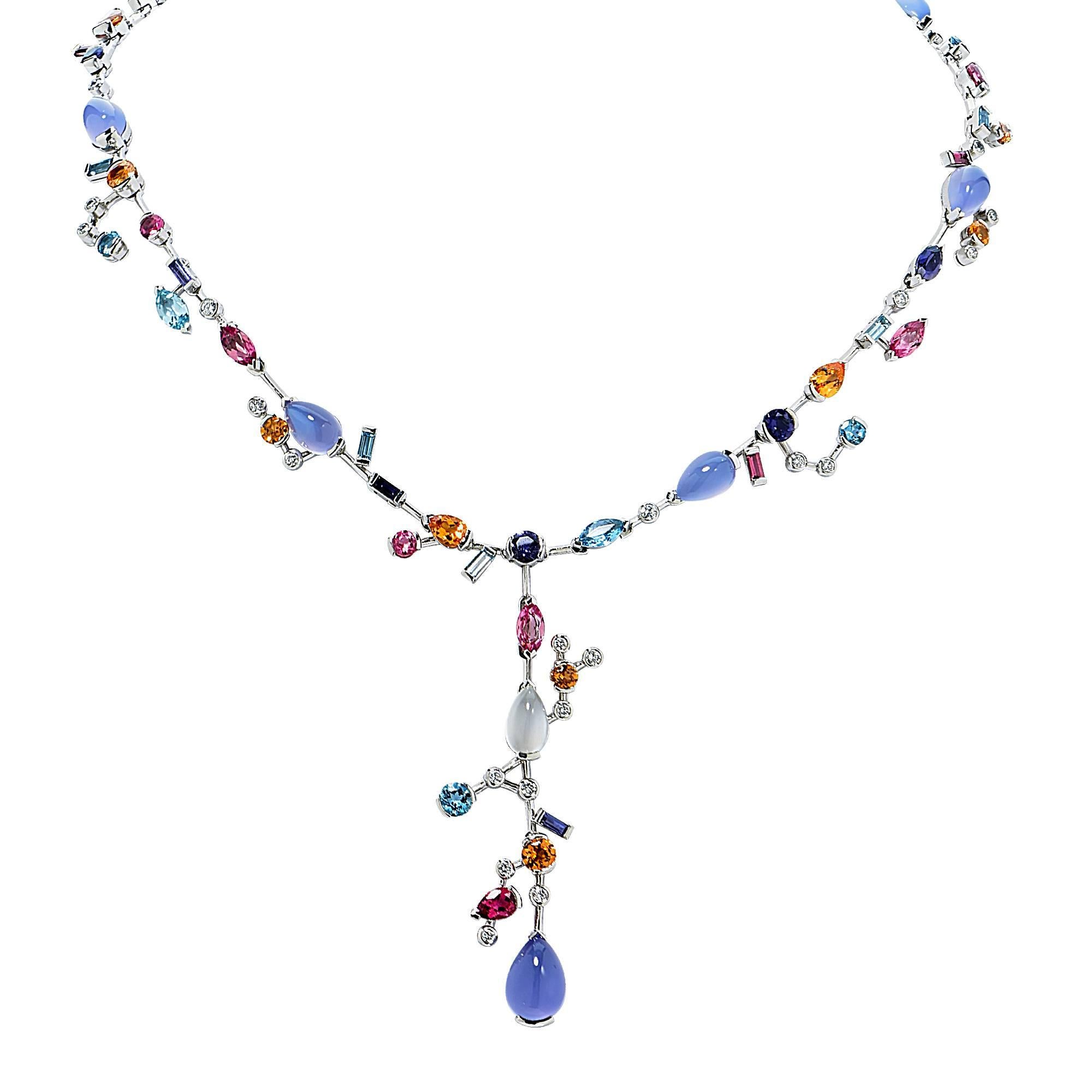 Platinum Cartier Meli Melo Necklace containing a melange of multicolored gemstones and diamonds set in a whimsical fashion and ending in a lariat. Gemstones include pink tourmaline, aquamarine, iolite, garnet, chalcedony and moonstone with round
