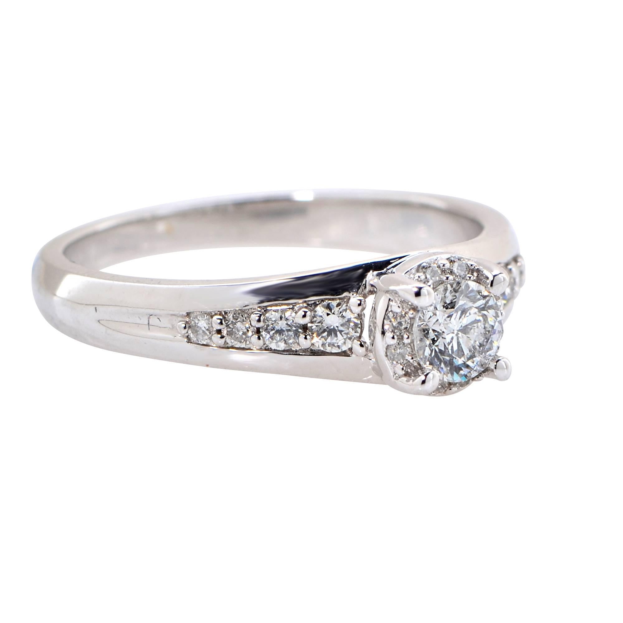 14k white gold engagement ring featuring a round brilliant cut diamond weighing .25ct, G color, SI3 clarity, surrounded by 16 round brilliant cut diamonds weighing .24ct total, G color, SI clarity.

Ring size: 7 (can be sized up or down)
Metal