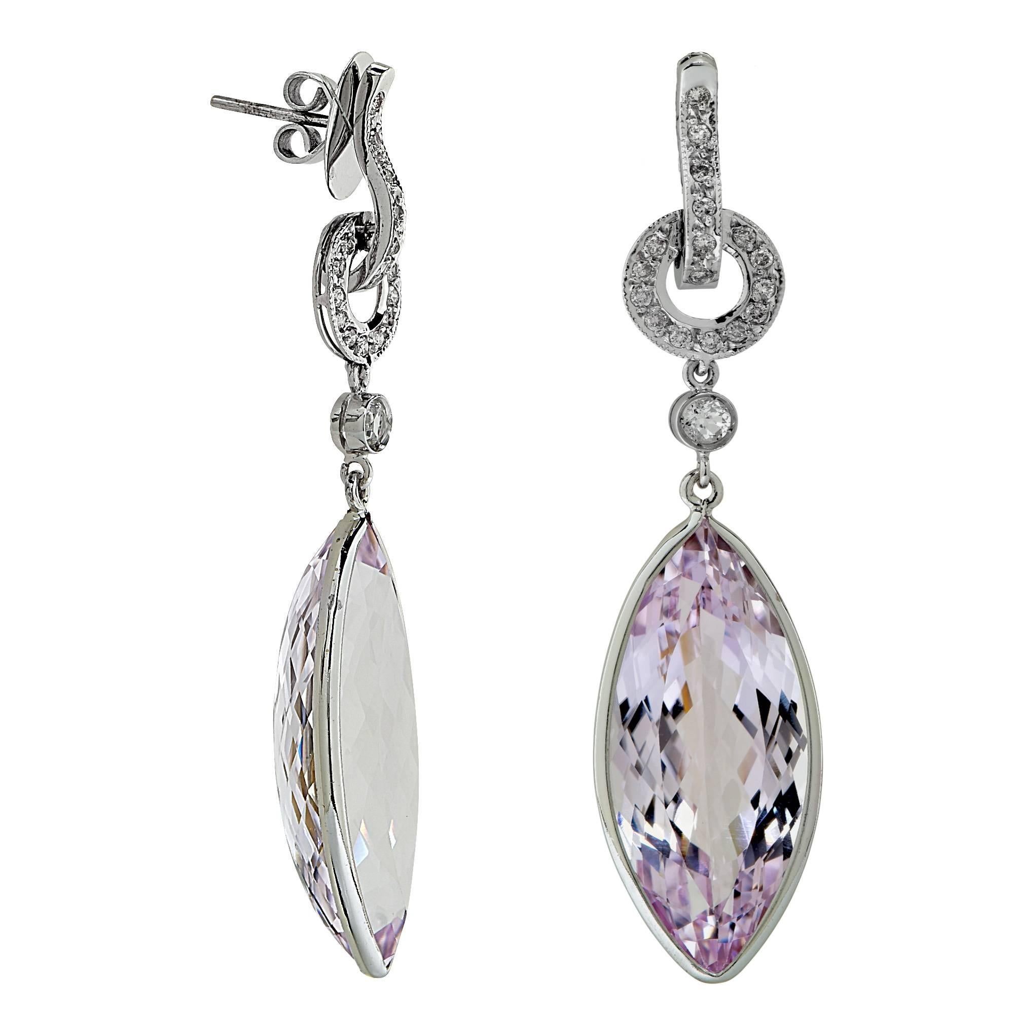 18k white gold earrings featuring 2 marquise shaped Kunzites weighing approximately 40cts, 2 round cut quartz and accented by 34 round brilliant cut diamonds weighing approximately .34cts total I color SI clarity.

It is stamped and tested as 18k