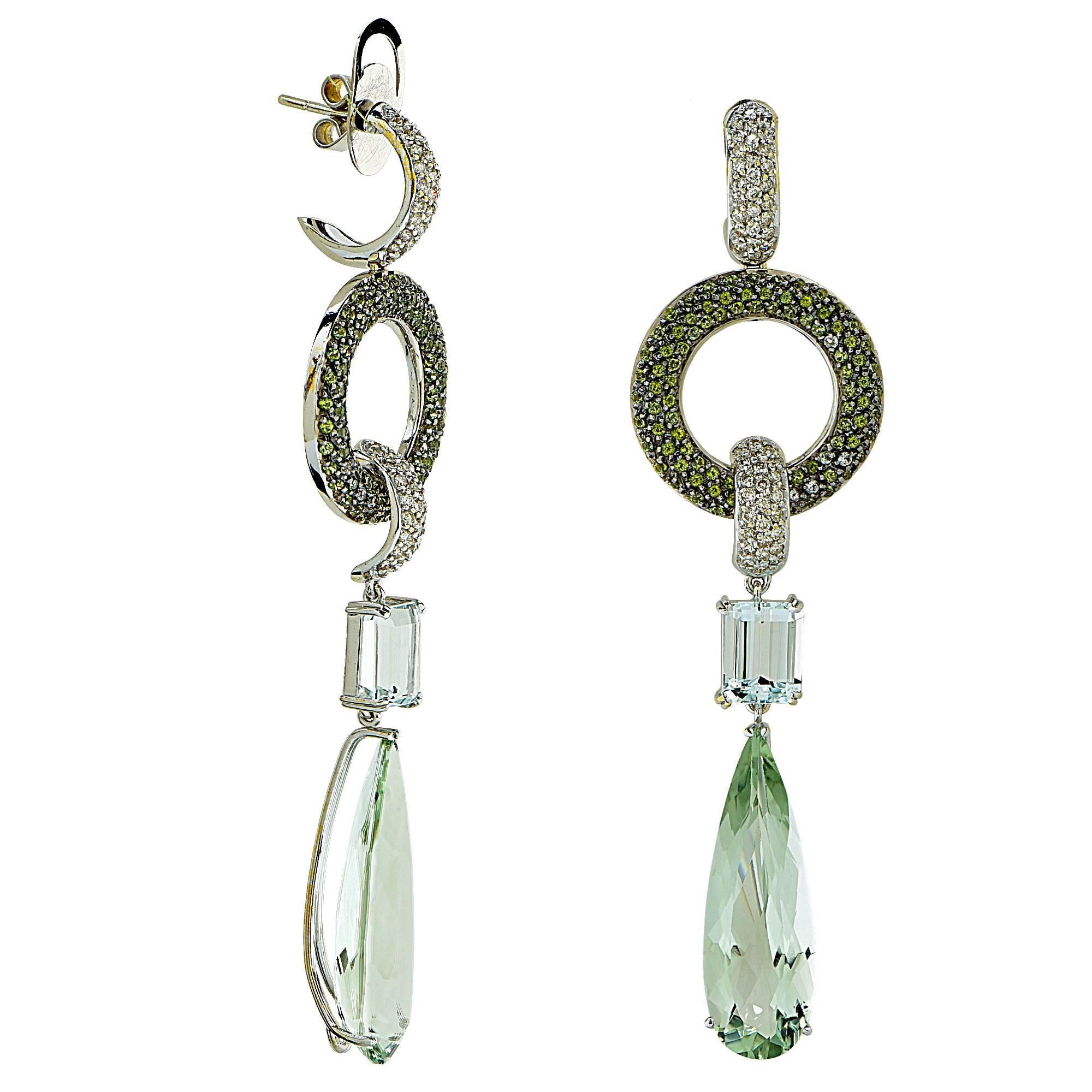 18k white gold earrings featuring 2 pear shape green quartz, 2 emerald cut aquamarines weighing approximately 5cts total, accented by approximately 1ct of round cut green quartz and 1ct of round brilliant cut diamonds H color SI clarity.

They are
