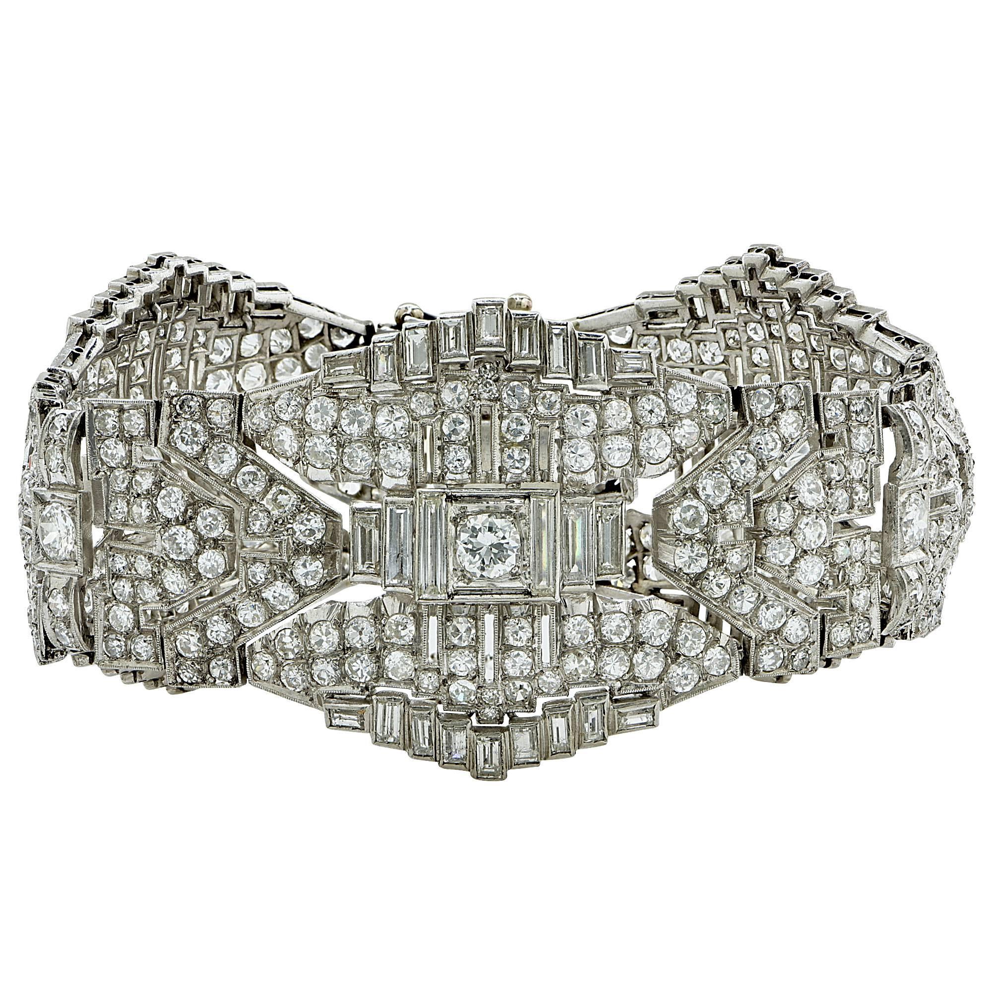 Platinum Art Deco bracelet featuring 355 European and baguette cut diamonds weighing approximately 23cts total, G-H color VS-SI clarity.

The bracelet measures 7 inches in length and 1.37 inches in width at the widest part.
It is stamped and