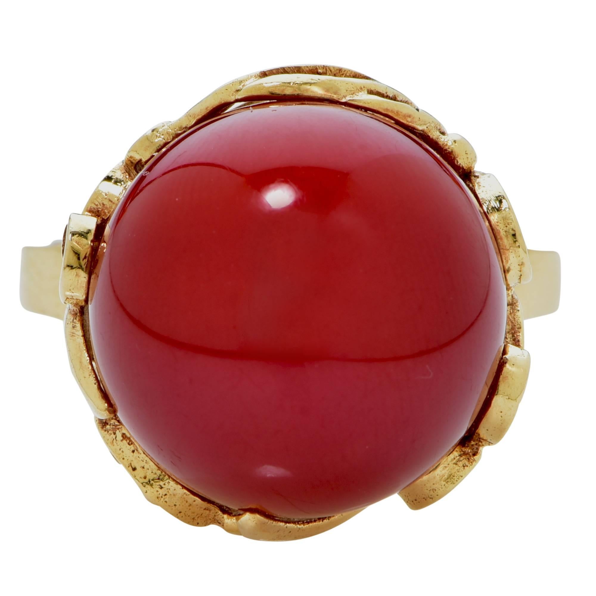 18k yellow gold vintage ring featuring a ox blood coral cabochon 14.2mm.

The ring is a size 7 and can be sized up or down.
It is stamped and tested as 18k gold.
The metal weight is 8.24 grams.

This coral ring is accompanied by a retail