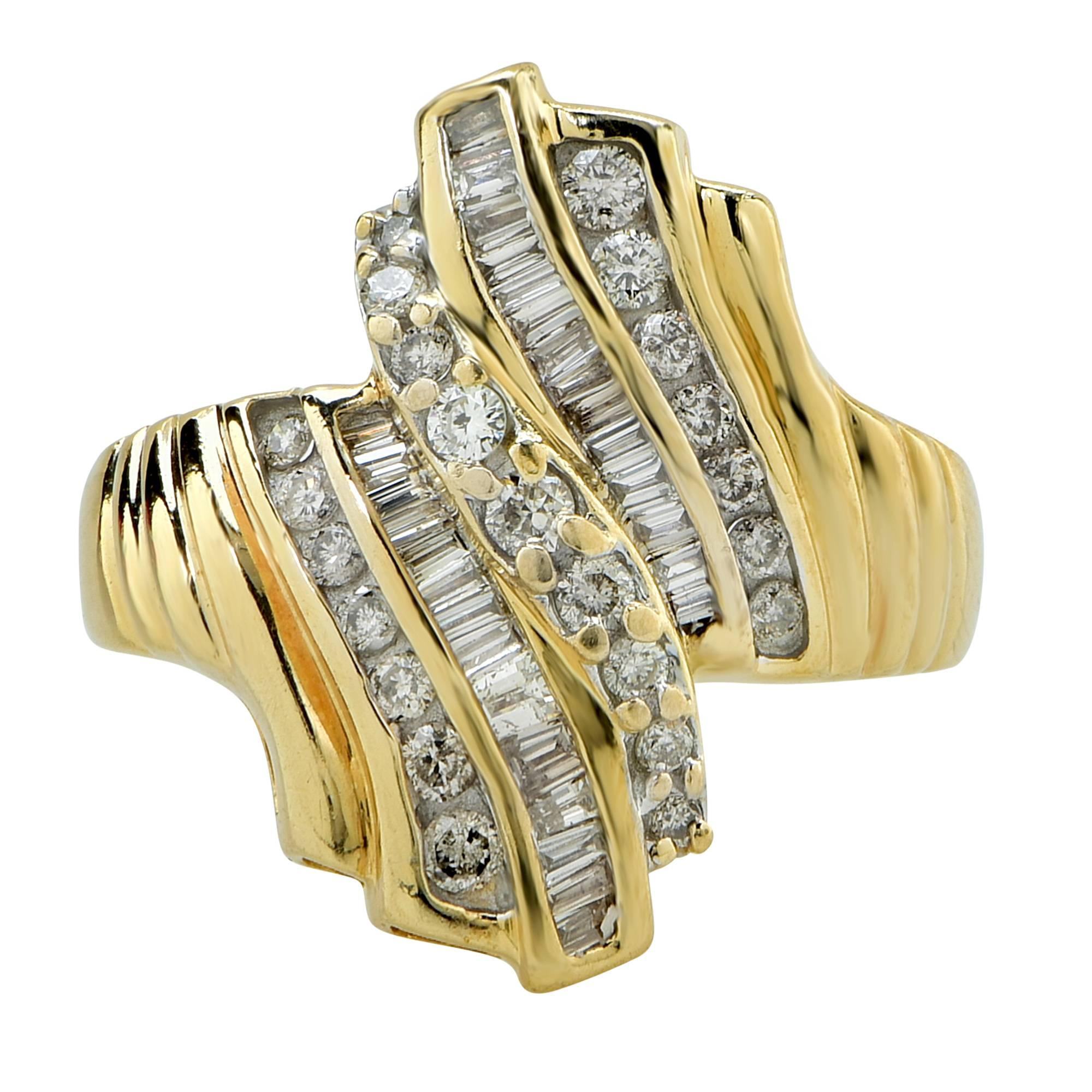14k yellow gold ring featuring 51 round brilliant and tapered baguette cut diamonds weighing approximately 1ct total, H color SI clarity.

The ring is a size 9 and can be sized up or down.
It is stamped and tested as 14k gold.
The metal weight