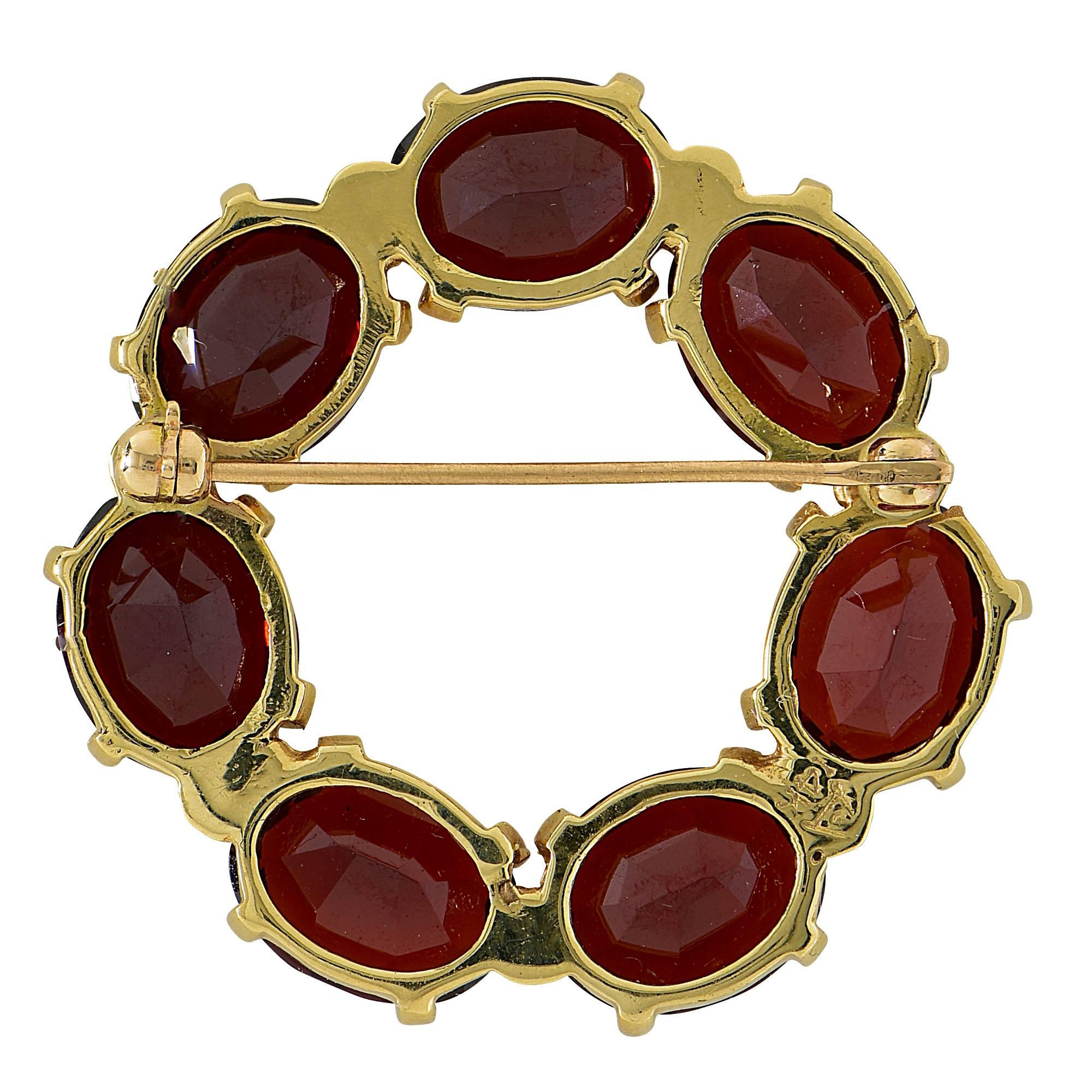 14k yellow gold rhodolite garnet brooch.

The brooch measure 1.25 inches in height by 1.36 inches in width by .27 inch in depth.
It is stamped and tested as 14k gold.
The metal weight is 9.25 grams.

This brooch is accompanied by a retail