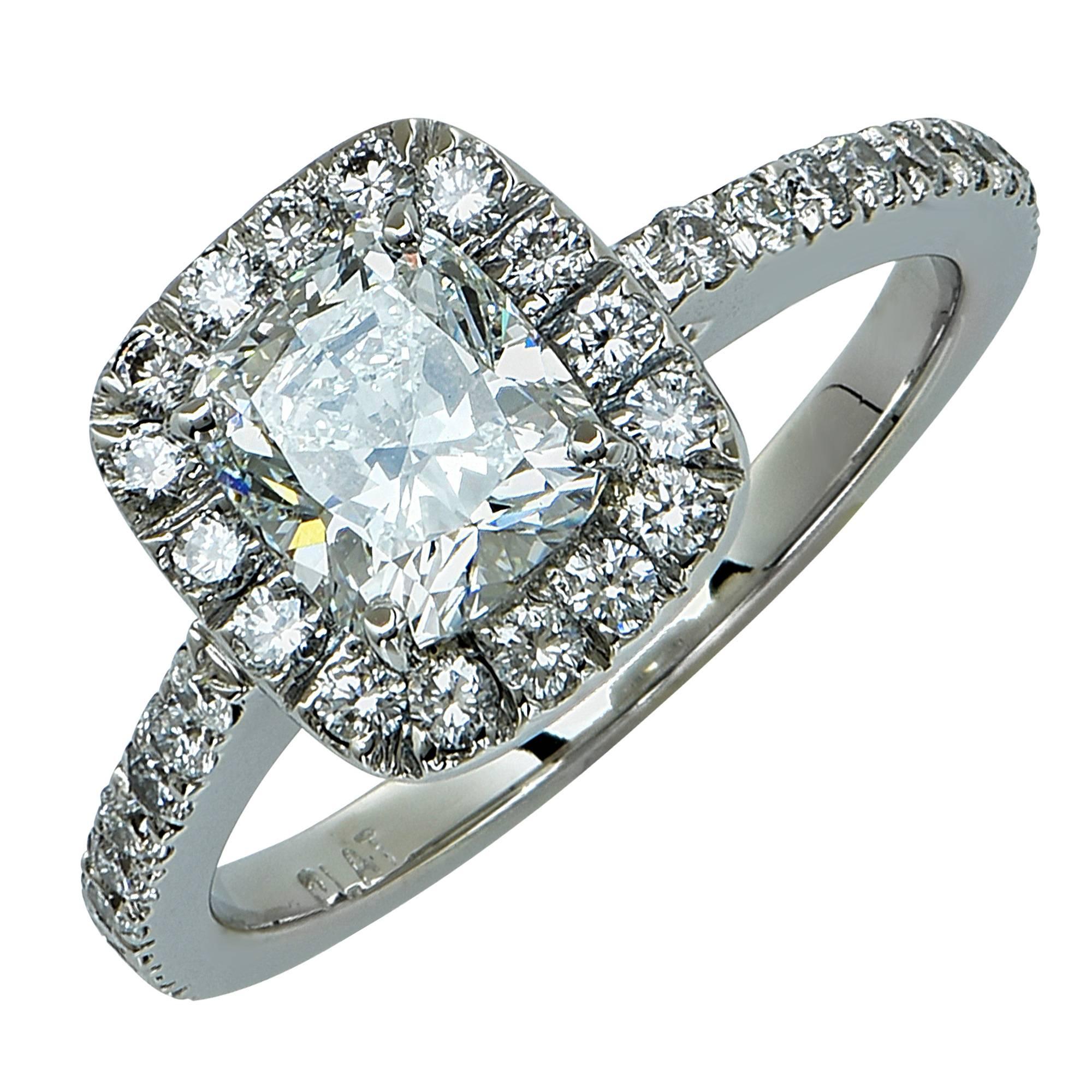 Platinum custom-made ring featuring a 1.29ct F color VS2 clarity GIA cushion cut diamond accented by 34 round brilliant cut diamonds weighing approximately .70cts total F color VS clarity.

The ring is a size 6.5 and can be sized up or down. It