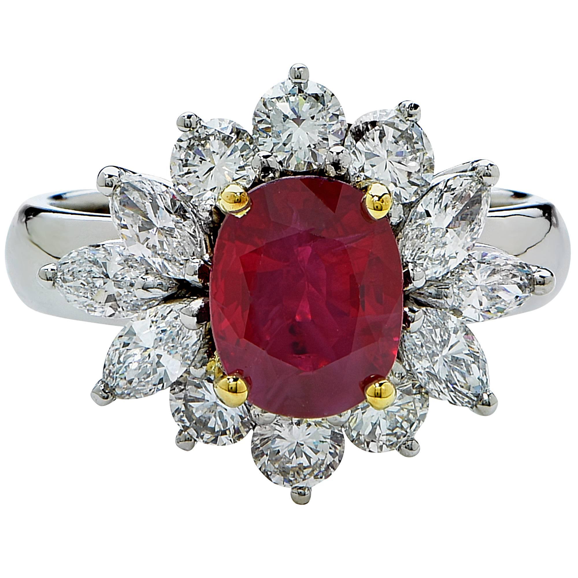 Platinum and 18k yellow gold ring featuring a 2.18ct oval cut heated Burma ruby accented by 12 round brilliant and marquise cut diamonds weighing approximately 1.8cts total, G color VS clarity.

The ring is a size 6.5 and can be sized up or