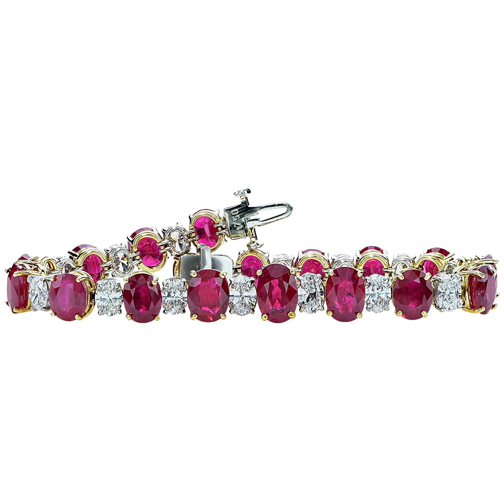 Platinum and 18k yellow gold bracelet featuring 18 AGL graded oval cut vibrant red Burma rubies weighing approximately 26cts total, accented by 18 oval cut diamonds weighing approximately 6.5cts total, F color VS clarity.

The bracelet is 7 inches