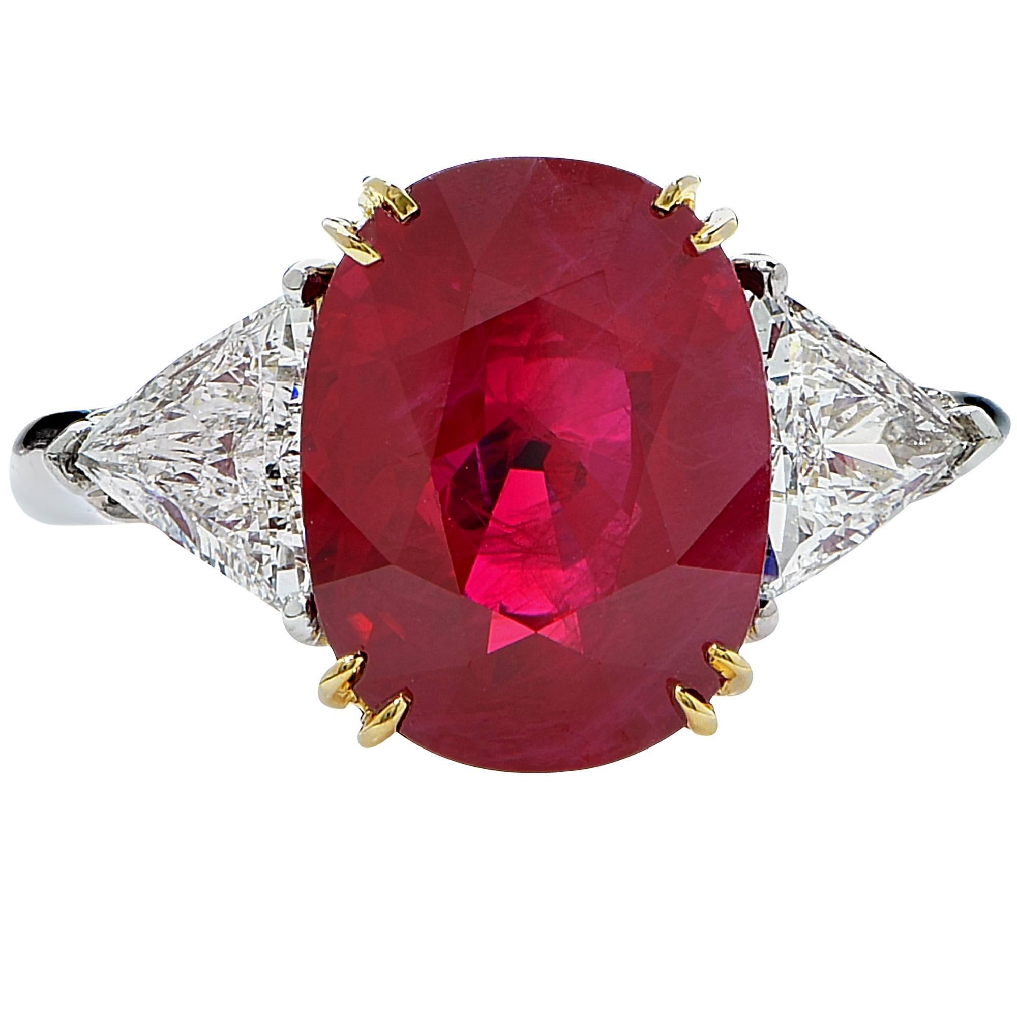 Platinum and 18k yellow gold hand-made ring featuring a 5.15ct oval cut vibrant red Burma Ruby flanked by 2 trillion cut diamonds weighing approximately 1ct total F color VS clarity.

This gorgeous ring is a size 5.75 and can be sized up or