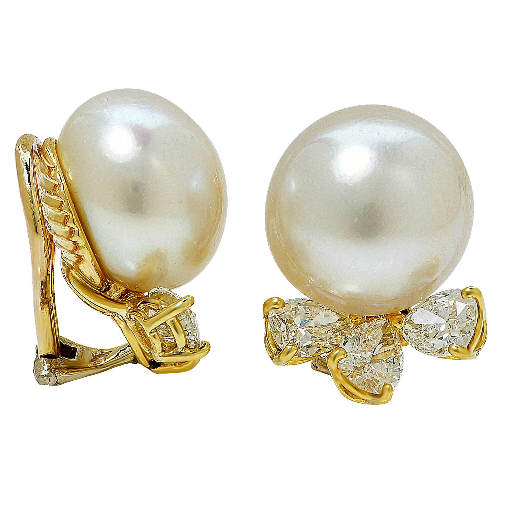 18k yellow gold earrings featuring 2 pearls measuring 13.6mm accented by 6 pear shape diamonds weighing approximately 3cts total, G-H color VS-SI clarity.

The earrings measure .76 inch in height by .61 inch in width by .53 inch in depth.
It is