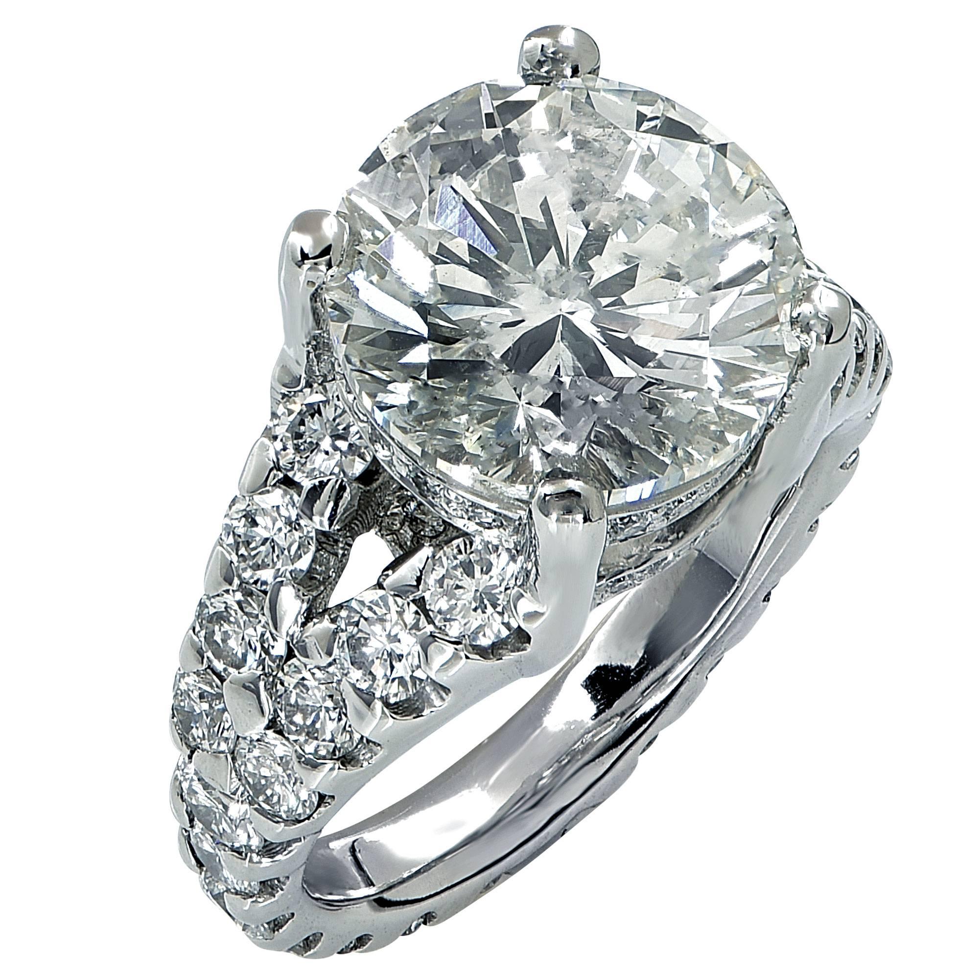 Platinum custom made ring featuring an EGL graded 7.01ct round brilliant cut diamond I color SI2 clarity accented by 54 round brilliant cut diamonds weighing approximately 3cts total, G-H color VS clarity.

The ring is a size 7 and cannot be