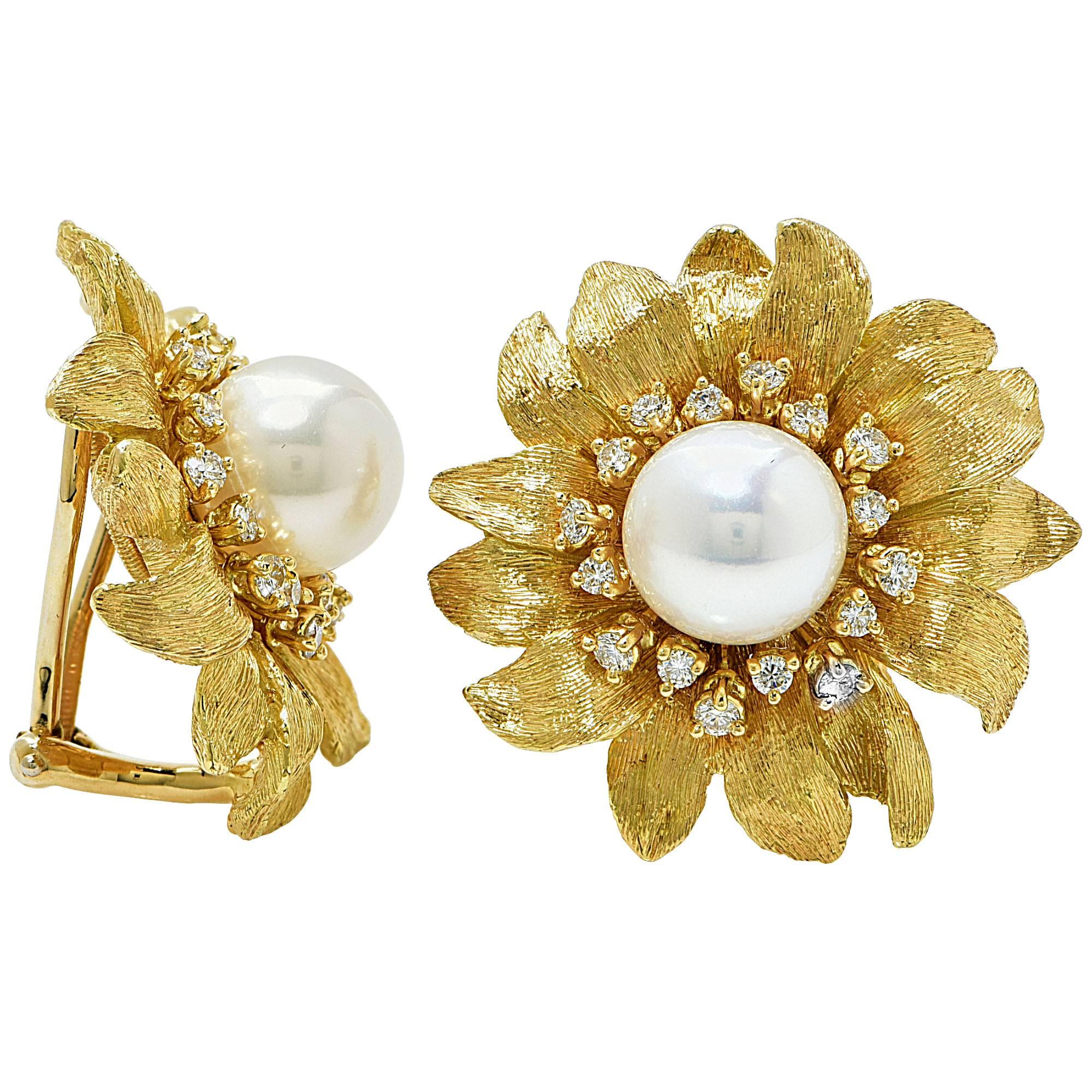 18K yellow gold brush finish flower earrings featuring a large akoya pearl with in a frame of 32 round brilliant cut diamonds weighing approximately 1.75cts F-G Color and VVS clarity.

These beautiful earrings are signed Bielka from the Sunflower