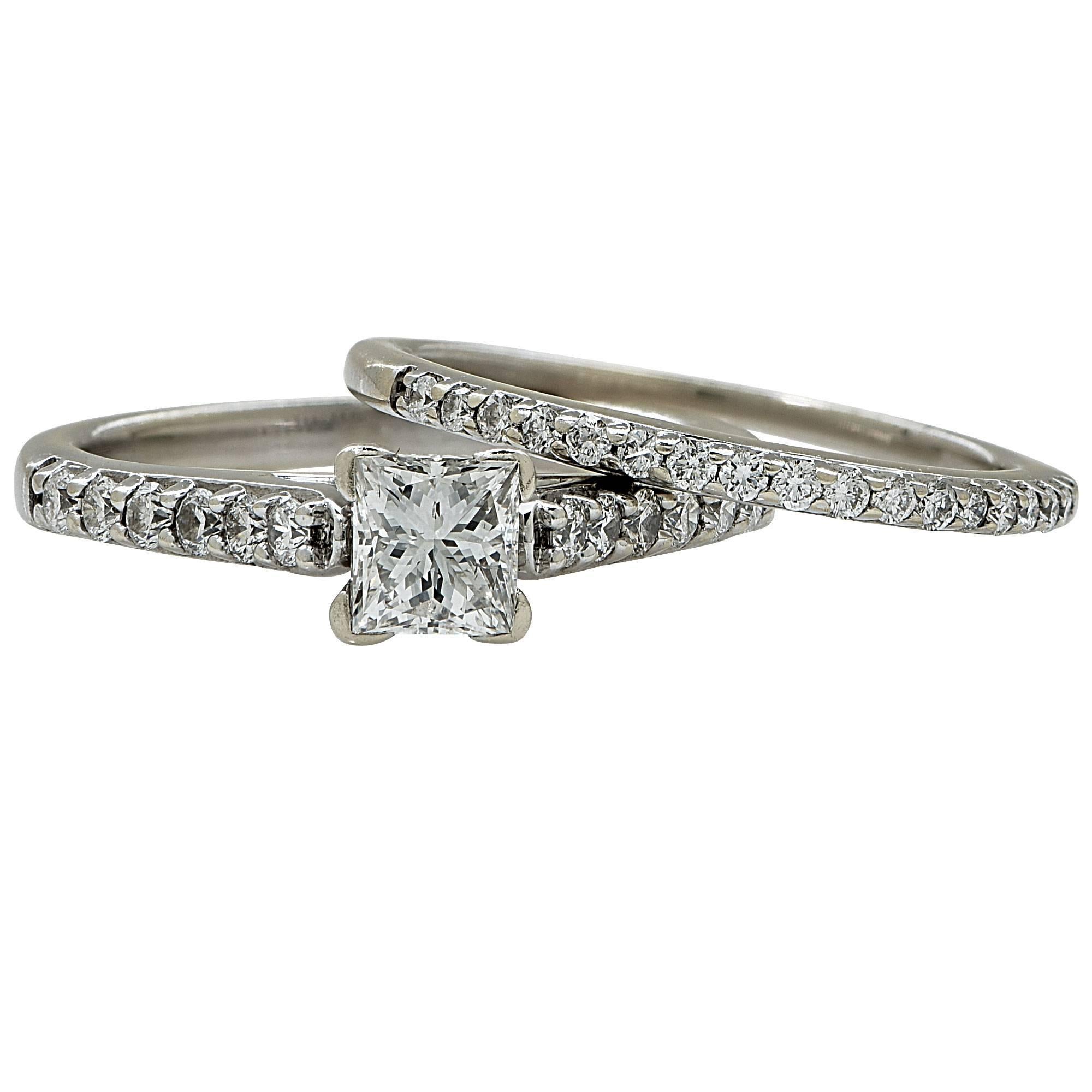 18k white gold wedding set featuring a .71ct F color I1 clarity princess cut diamond accented by .50cts of round brilliant cut diamonds E-F color SI2-I1 clarity.

The ring is a size 6.5 and can be sized up or down.
It is stamped and tested as 18k