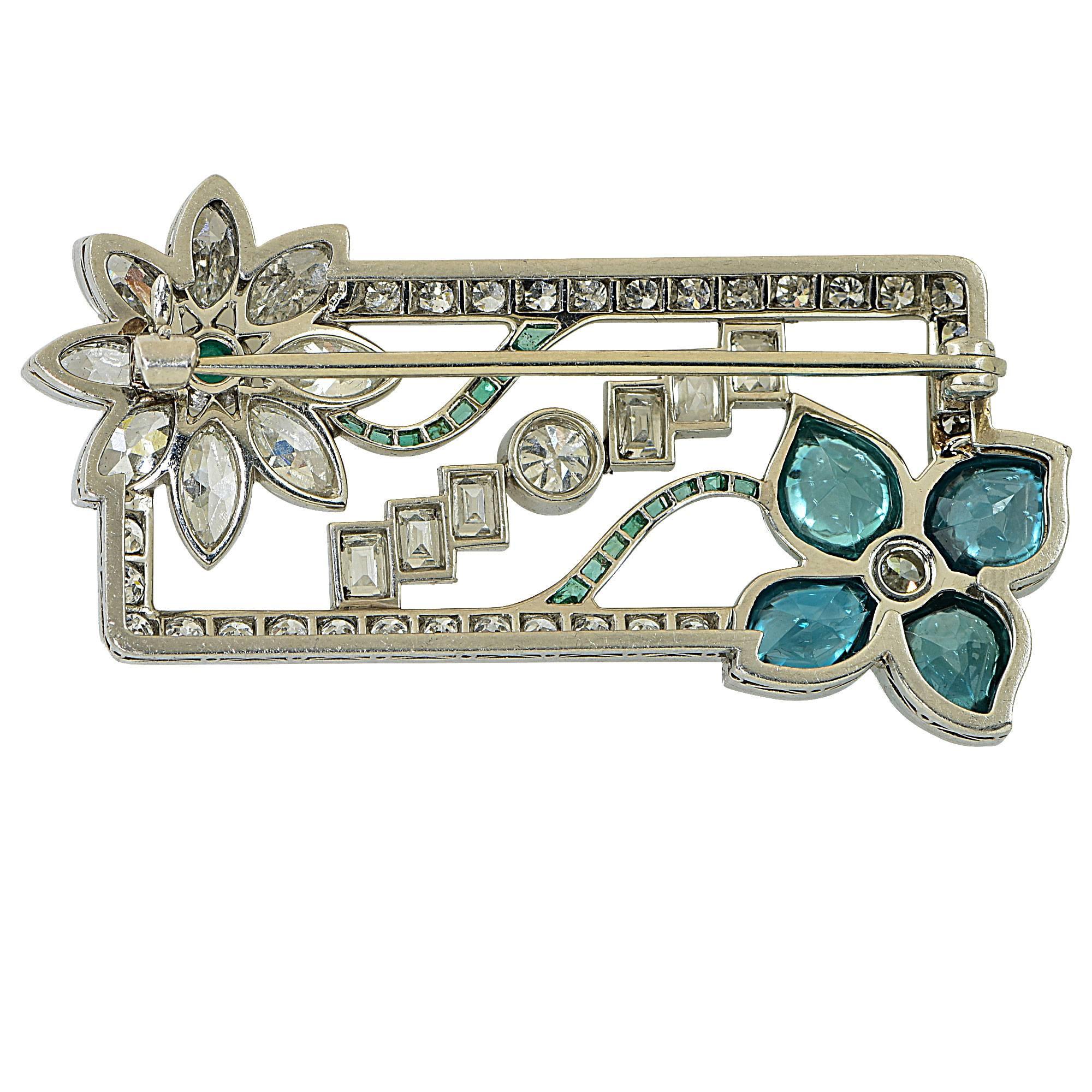 Platinum Deco brooch featuring approximately 5cts of European, baguette and marquise cut diamonds, G color VS clarity. Accented by emerald and zircon cabochons.

It is stamped and tested as platinum.
The metal weight is 13.06 grams.

This