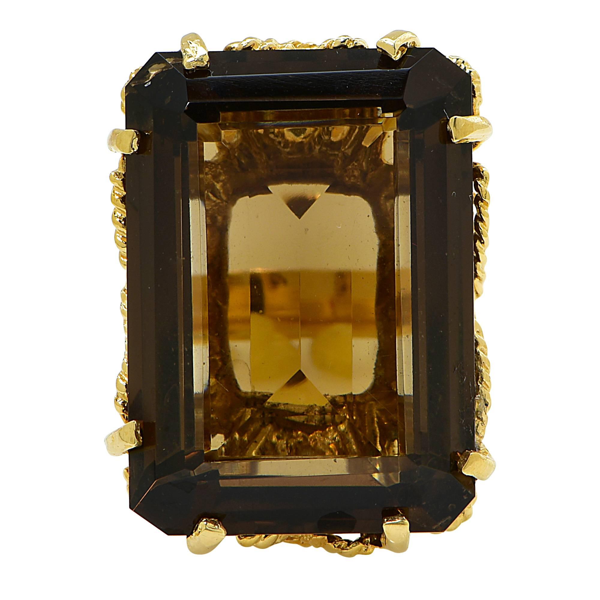 14k yellow gold vintage ring featuring an emerald cut smoky quartz weighing approximately 30cts.

The ring is a size 7 and can be sized up or down.
It is stamped and tested as 14k gold.
The metal weight is 14.92 grams.

This smoky quartz ring is