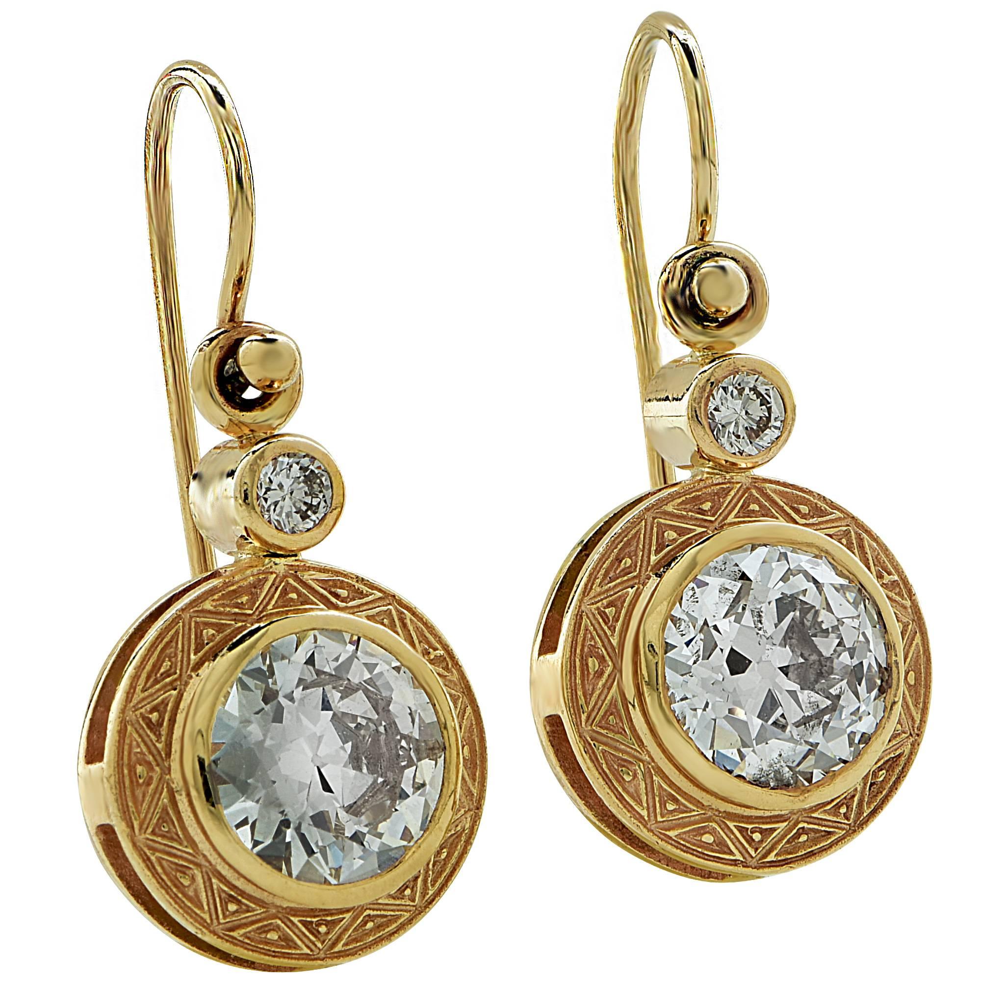 Yellow gold earring containing 2 European cut diamonds weighing approximately 3ct total H-I color and VS2-SI2 clarity accented by 2 round brilliant cut diamonds weighing approximately .15cts.

It is stamped and tested as 18k gold.
The metal