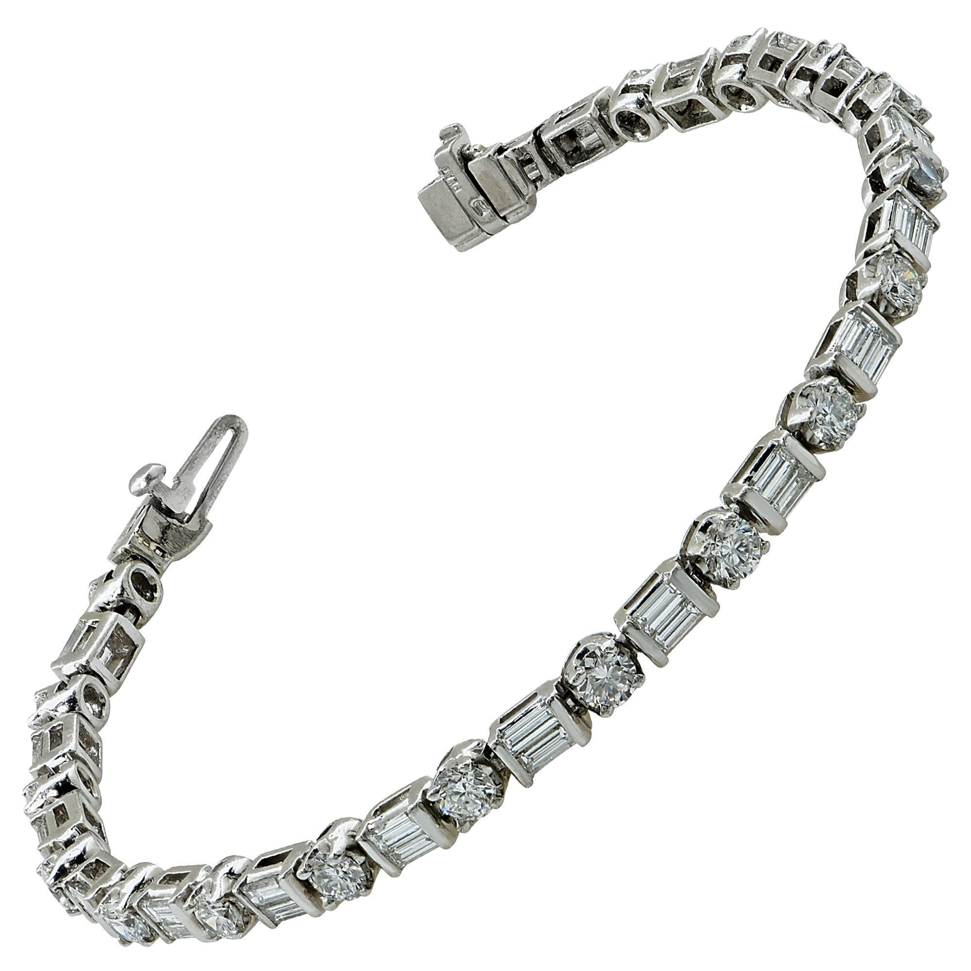 Platinum bracelet containing 18 round brilliant cut diamonds weighing approximately 2.75cts and 38 baguette cut diamonds weighing approximately 2cts G color and VS clarity.

This gorgeous bracelet measures 7 inches in length.
It is stamped and