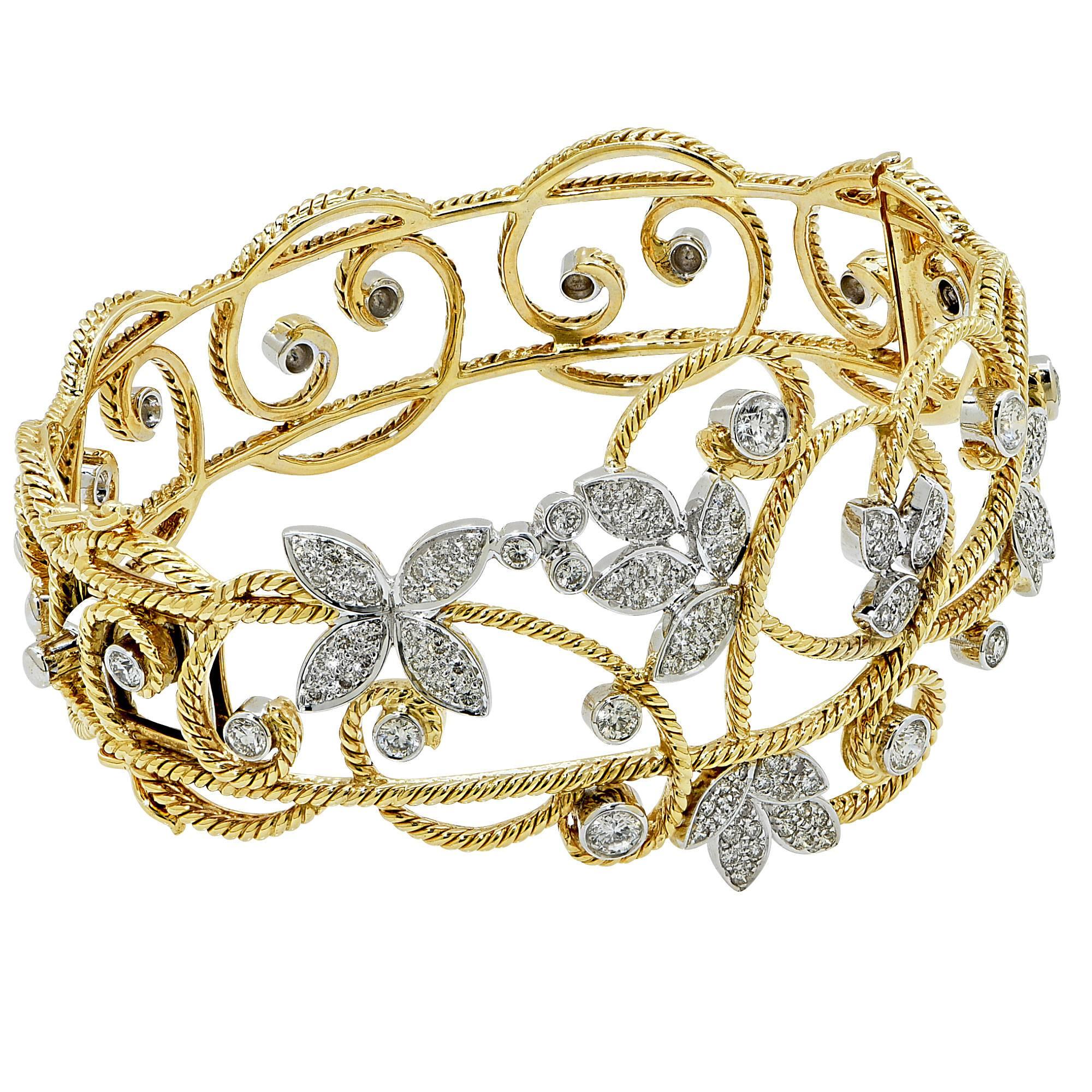 18k white and yellow gold bangle bracelet featuring 122 round brilliant cut diamonds weighing approximately 3cts total G color VS clarity.

The bracelet measures 7 inches in circumference by 2.30 inches in height by 2.60 inches in width by 1.35