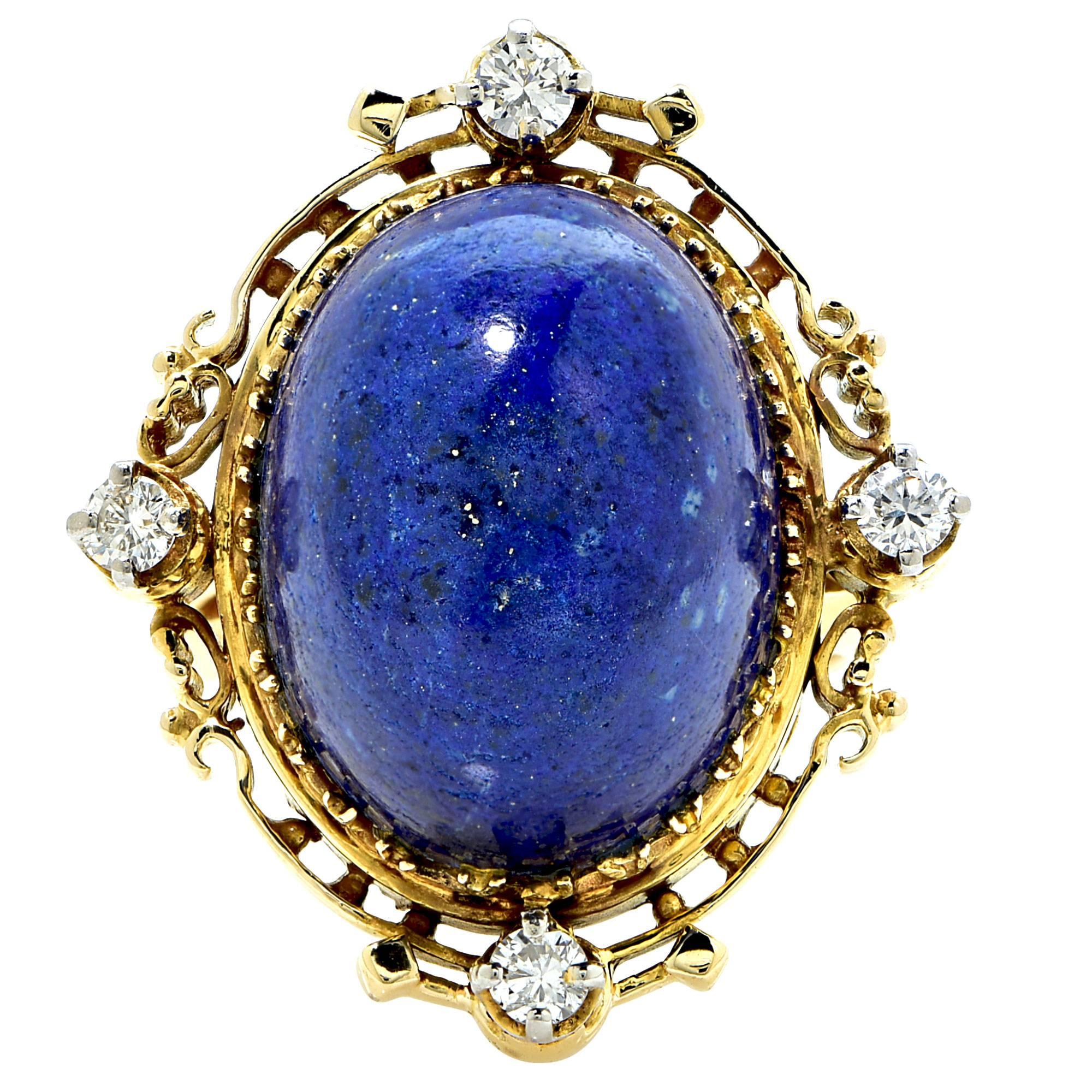 14k yellow gold ring featuring a lapis cabochon accented by 4 round brilliant cut diamonds weighing approximately .40cts total, G color VS clarity.

The ring is a size 5 and can be sized up or down.
It is stamped and tested as 14k gold.
The