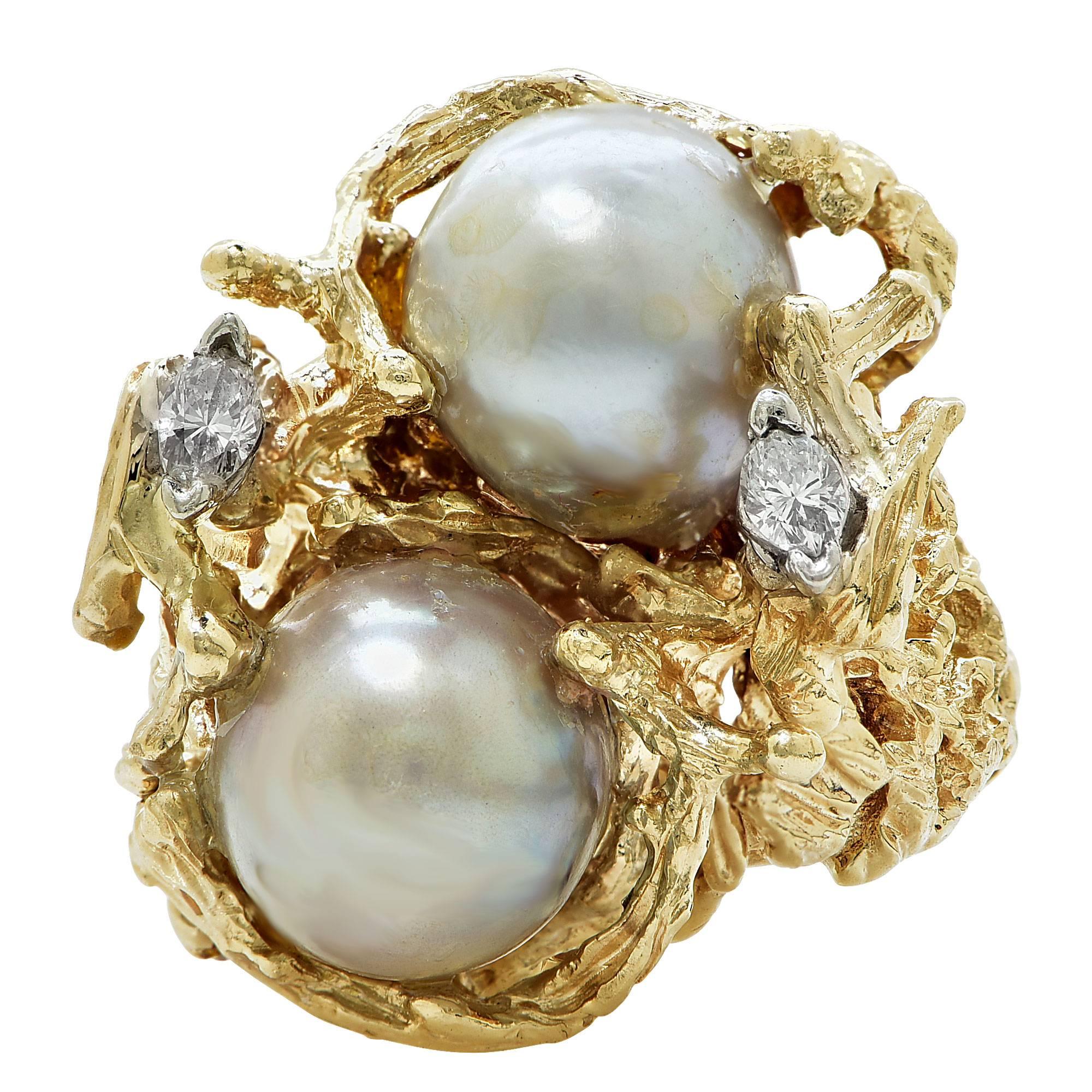14k yellow gold ring featuring 2 fresh water pearls measuring 10mm accented by 2 marquise cut diamonds weighing .10cts total I color VS clarity.

The ring is a size 6 and can be sized up or down.
It is stamped and tested as 14k gold.
The metal