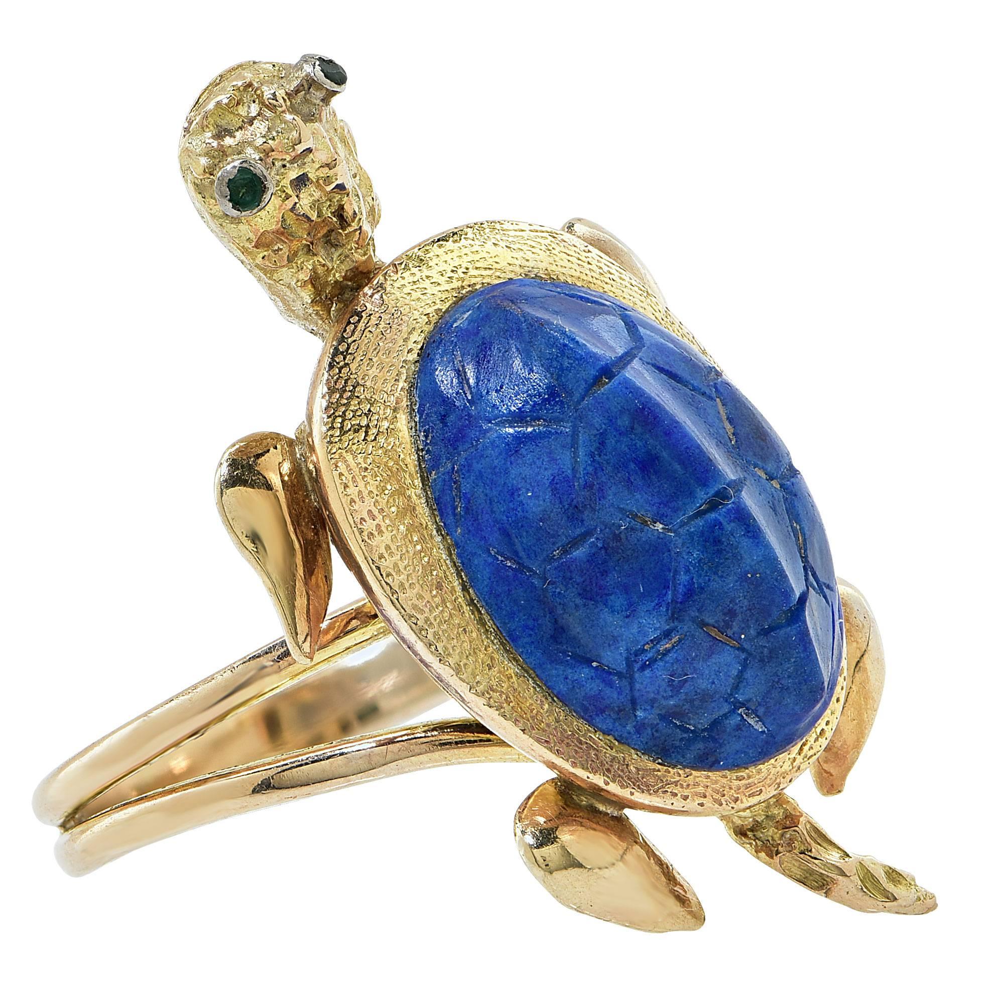 14k yellow gold ring featuring a carved lapis Turtle with round cut emeralds as eyes.

It is stamped and tested as 14k gold.
The metal weight is 8.24 grams.

This lapis bold ring is accompanied by a retail appraisal performed by a GIA Graduate