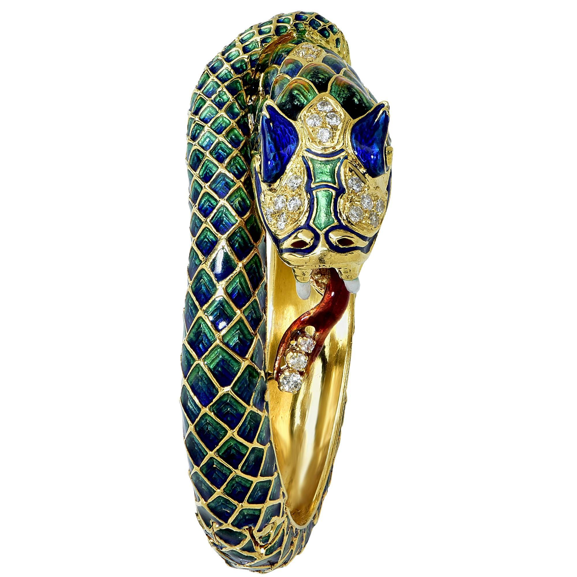 18k yellow gold snake bangle. This gorgeous snake bangle is accented with blue and green enamel and contains 21 mixed cut diamonds weighing approximately .75cts.

It is stamped and tested as 18k gold.
The metal weight is 90 grams.

This diamond and