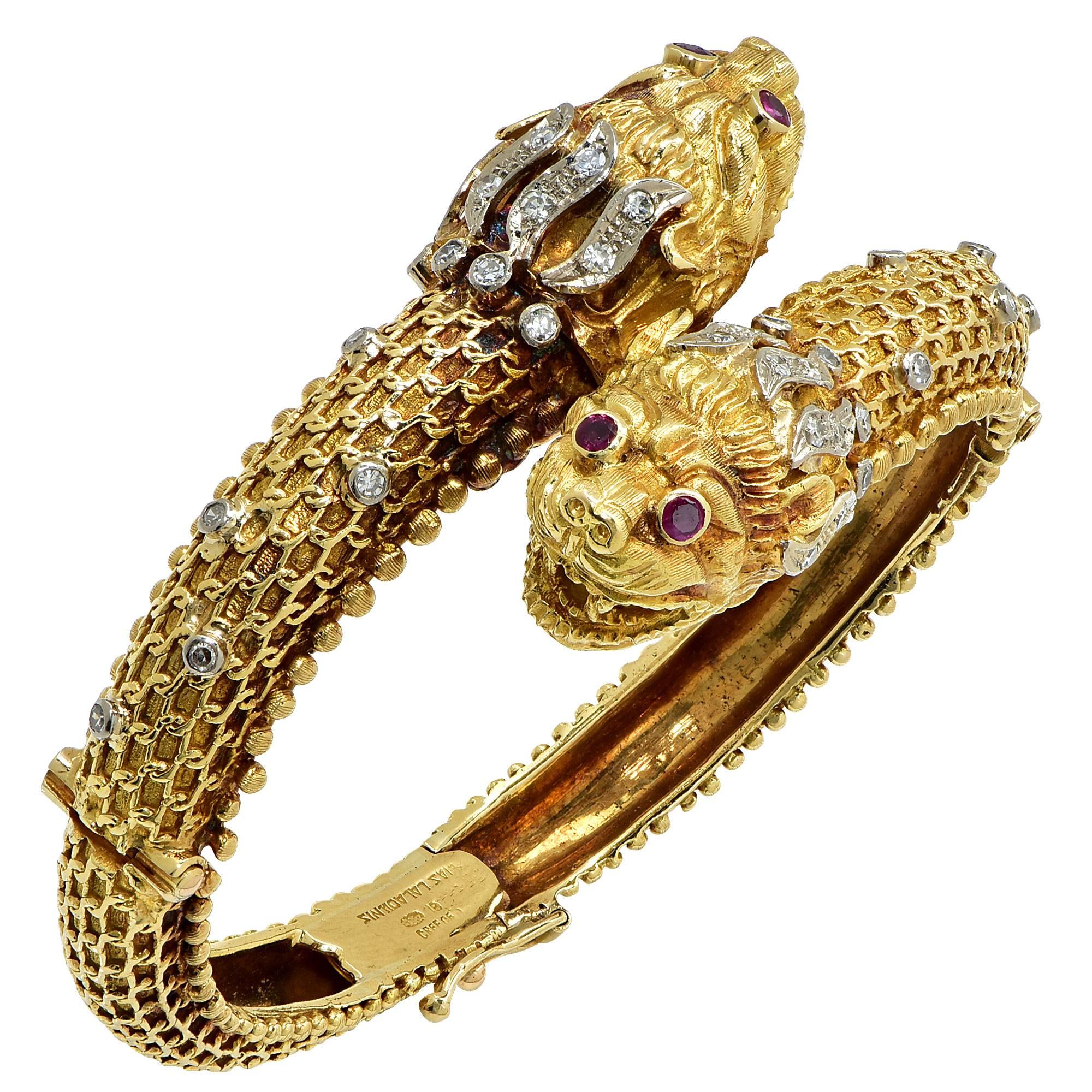 18k yellow gold bangle, created in Greece by world renowned Ilias Lalounis, containing 4 round cut rubies weighing approximately .30cts and 34 single cut diamonds weighing approximately .70cts.

It is stamped and tested as 18k gold.
This unique