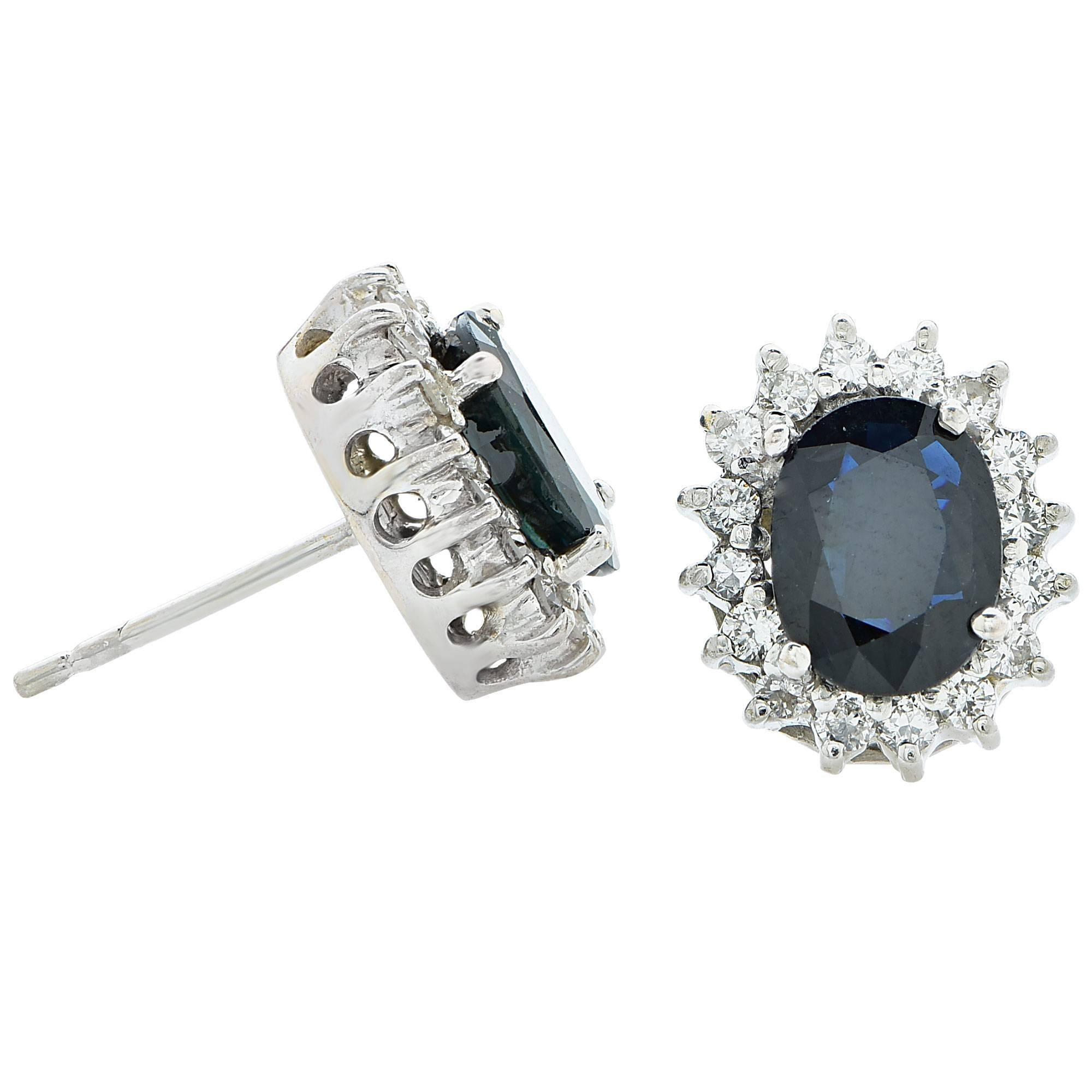 18k white gold earrings featuring 2 oval cut sapphires weighing approximately 3cts total accented by 32 round brilliant cut diamonds weighing approximately .80cts total, G color VS clarity.

It is stamped and tested as 18k gold.
The metal weight is