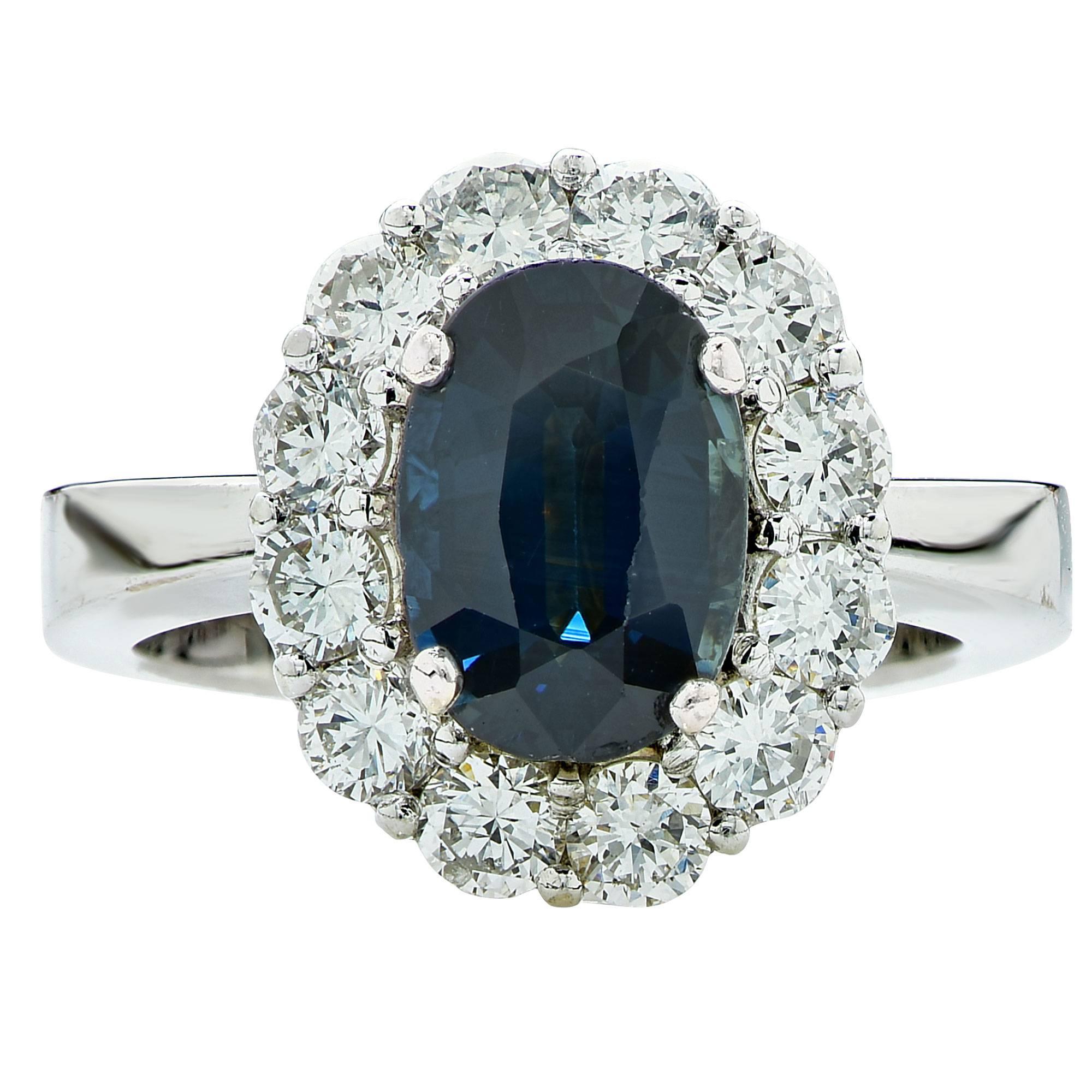 Platinum ring featuring an oval cut Sapphire weighing approximately 1.50cts accented by 12 round brilliant cut diamonds weighing approximately 1.20cts total, G color VS clarity.

The ring is a size 5 and can be sized up or down.
It is stamped and