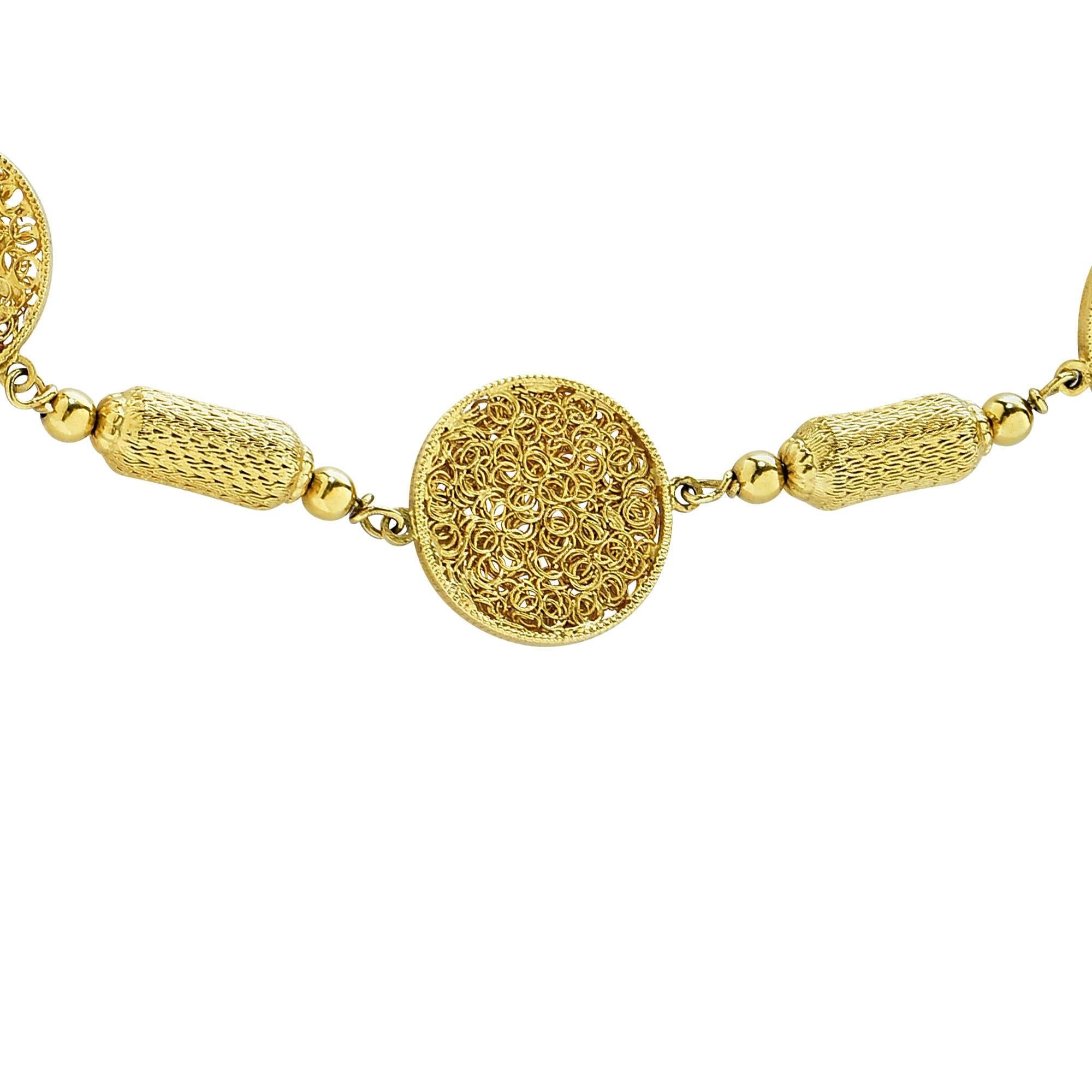 18k yellow gold necklace, custom made in Italy, highlighting intricate gold wire circular pieces alternating with hand etched and woven gold bars.

This necklace is a work of art and measures 28 inches in length.
It is stamped and tested as 18k