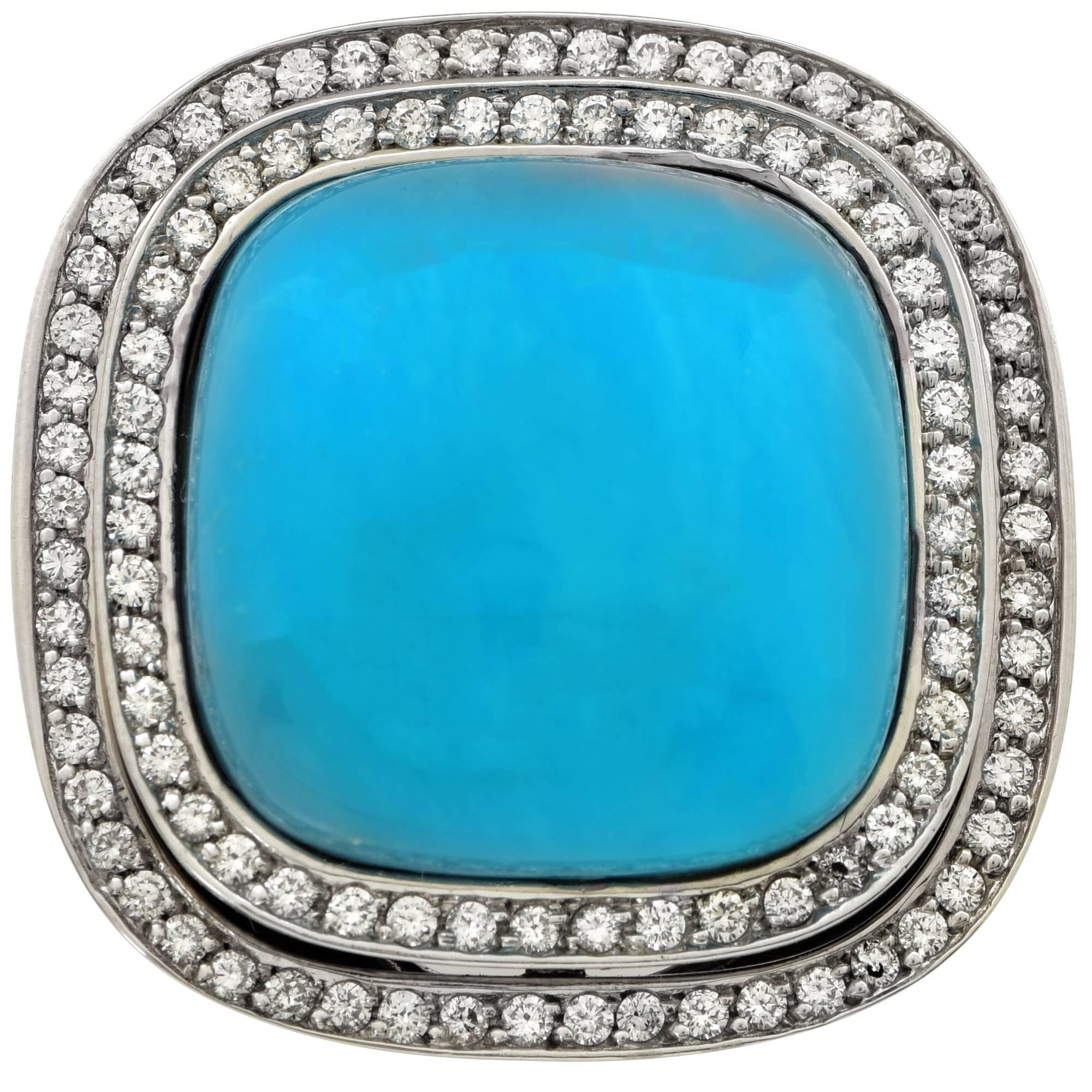 18k white gold ring featuring a cabochon cut Turquoise surrounded by 100 round brilliant cut diamonds weighing approximately 1.5cts total, G color VS clarity.

The ring is a size 6 and can be sized up or down.
It is stamped and/or tested as 18k