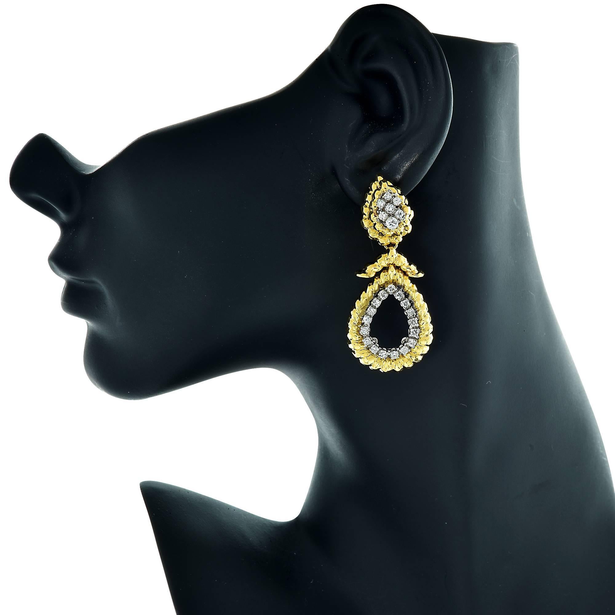 18k yellow and white gold earrings containing 48 round brilliant cut diamonds weighing approximately 1.60cts G color and SI clarity. These lever back earrings are beautiful and unique.

The earrings measure 54mm in length by 24mm in width.
It is