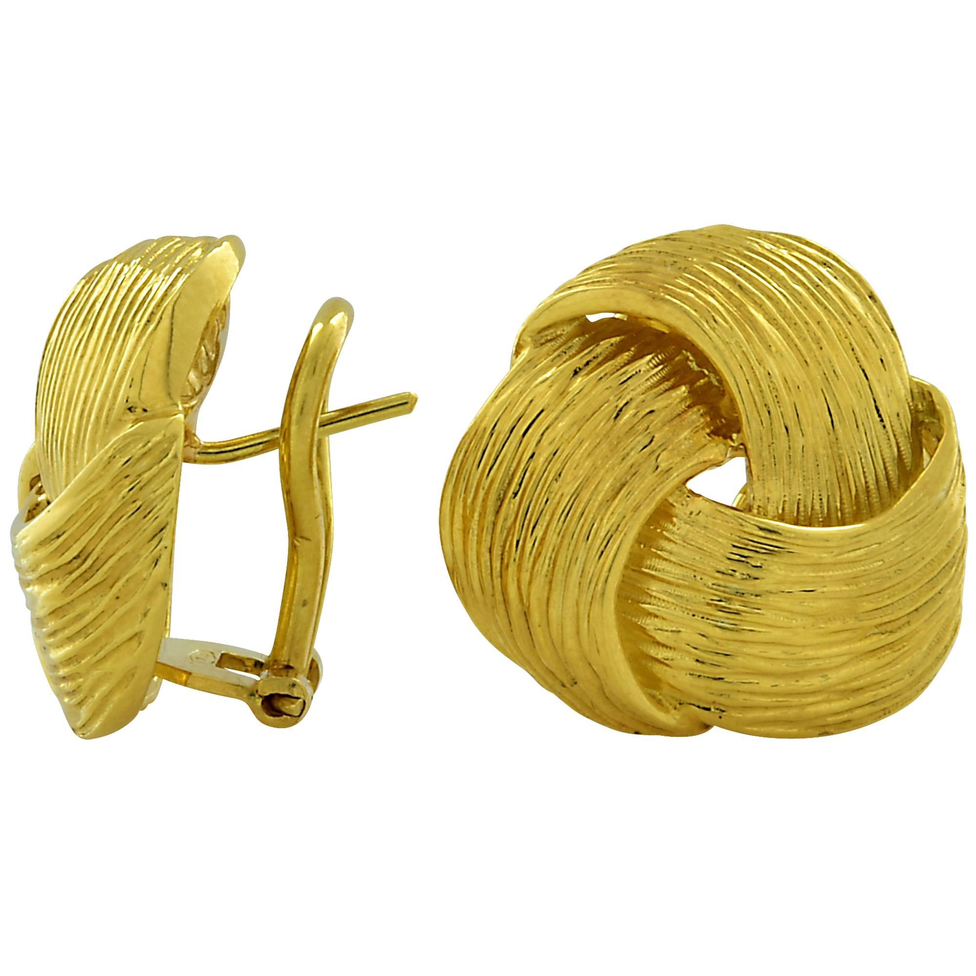 Beautiful 18k yellow gold earrings featuring a interwoven swirl design.

These earrings measure 20mm in diameter.
It is stamped and/or tested as 18k gold.
The metal weight is 13.20 grams.

These gold earrings are accompanied by a retail appraisal