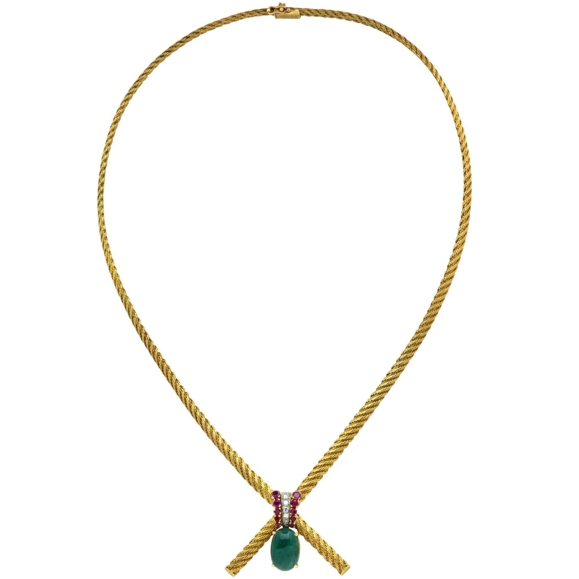 18k yellow gold necklace containing a green cabochon emerald accented by 10 rubies and 5 single and round brilliant cut diamonds. Signed Gubelin as well as French Hallmarked.

The necklace measures 19 inches in length and the pendant measures 1.10